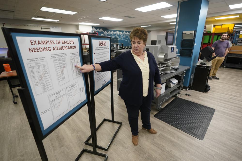 Utah County elections director Rozan Mitchell conducts a tour of Utah County's elections equipment and review processes Tuesday in Provo. In Utah and other Republican-led states, unsubstantiated election fraud claims have upended support for voting by mail.