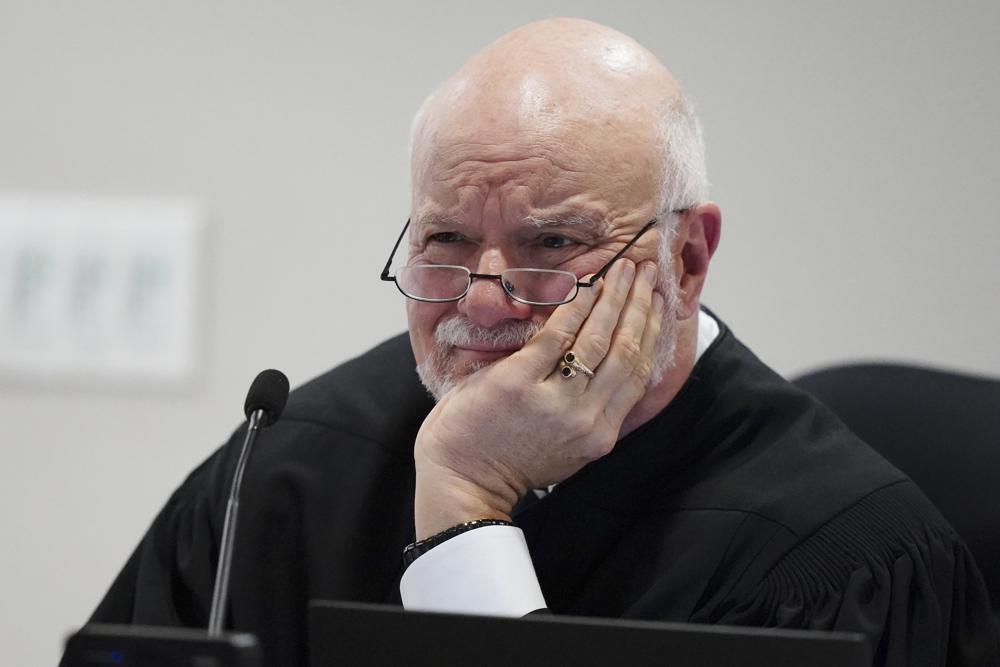 Judge Charles Beaudrot listens to arguments in the courtroom, Friday in Atlanta. U.S. Rep. Marjorie Taylor Greene is appearing at a hearing Friday in Atlanta in a challenge filed by voters who say she shouldn't be allowed to seek reelection because she helped facilitate the attack on the Capitol that disrupted certification of Joe Biden's presidential victory.