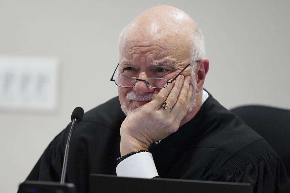 Judge Charles Beaudrot listens to arguments in the courtroom, Friday in Atlanta. U.S. Rep. Marjorie Taylor Greene is appearing at a hearing Friday in Atlanta in a challenge filed by voters who say she shouldn't be allowed to seek reelection because she helped facilitate the attack on the Capitol that disrupted certification of Joe Biden's presidential victory.