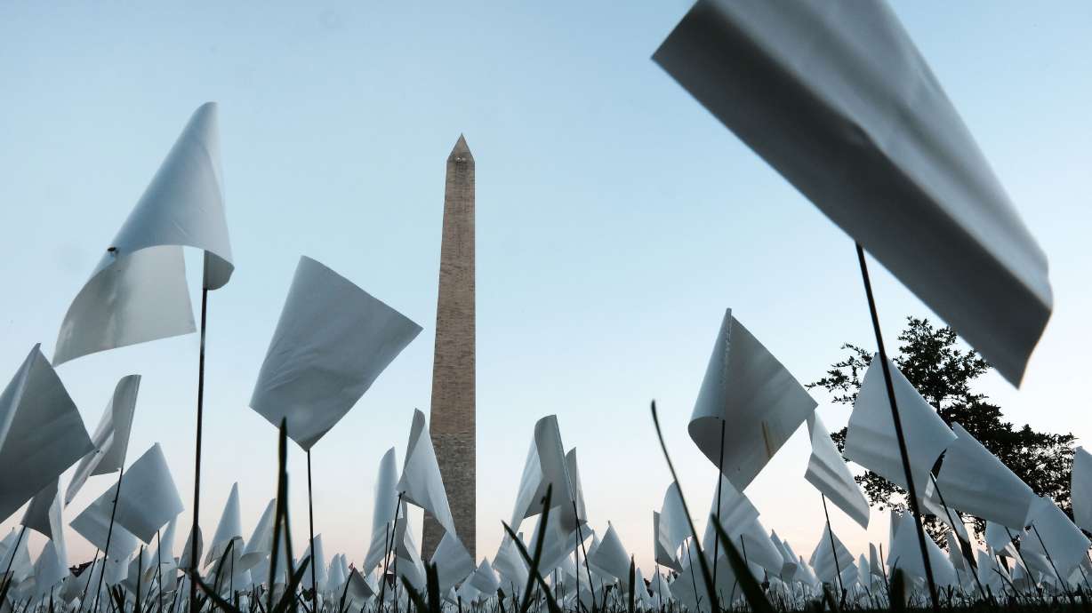 Flags are placed in the ground as part of 'In America: Remember,' a public art installation commemorating all the Americans who have died due to COVID-19 near the Washington Monument on Sept. 18, 2021, in Washington, D.C. COVID-19 was the third-leading cause of death in the U.S. in 2021.