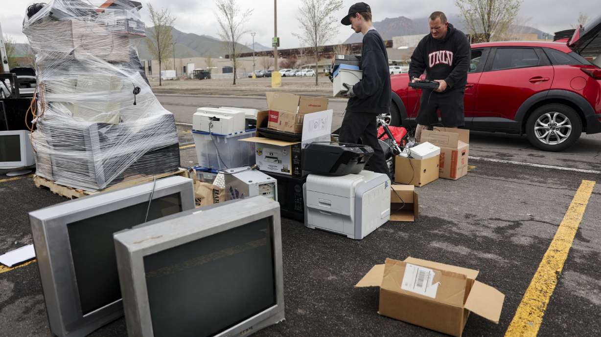 Aden Cornaby of Tams Electronic Recycling, left, and Jesse Graham of The Other Side Academy organize electronics for recycling at the annual Declutter Day at the University of Utah in Salt Lake City on Friday.