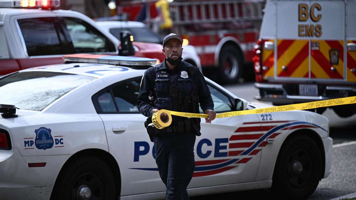 A police officer secures the area after a shooting Friday in northwest Washington, D.C.