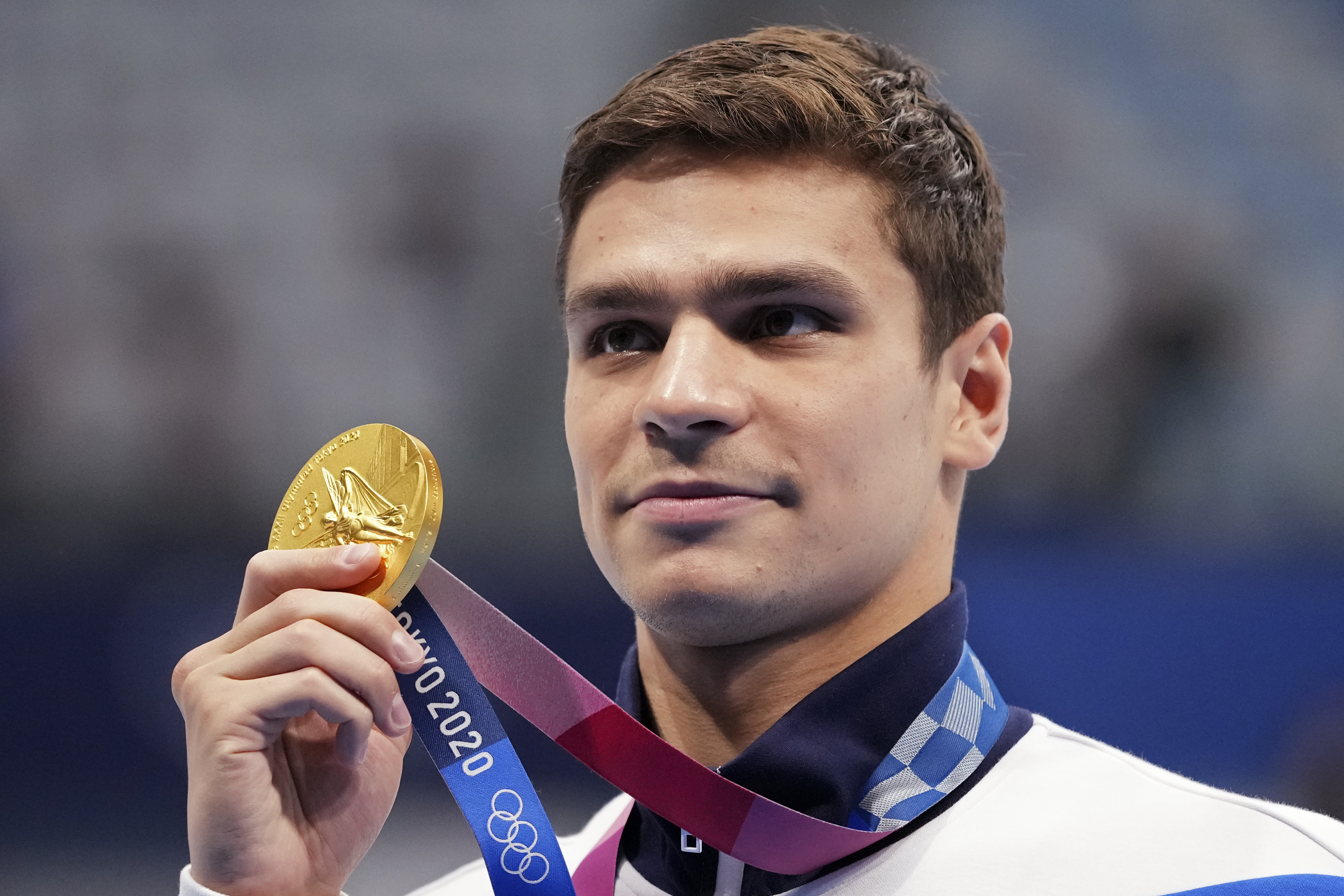 FILE - Evgeny Rylov of the Russian Olympic Committee poses with his gold medal for the men's 100-meter backstroke final at the 2020 Summer Olympics, Tuesday, July 27, 2021, in Tokyo, Japan. A statement from swimming's world governing body, FINA, on Thursday, April 21, 2022, announced that Rylov has been banned from the sport for nine months for appearing at a rally in support of President Vladimir Putin and Russia’s invasion of Ukraine.