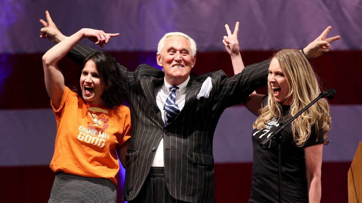 Sophie Anderson and Jen Orten, of Two Red Pills, stand with Roger Stone, a conservative political consultant and lobbyist, at a rally for 3rd District candidate Jason Preston at Thanksgiving Point in Lehi on Friday.