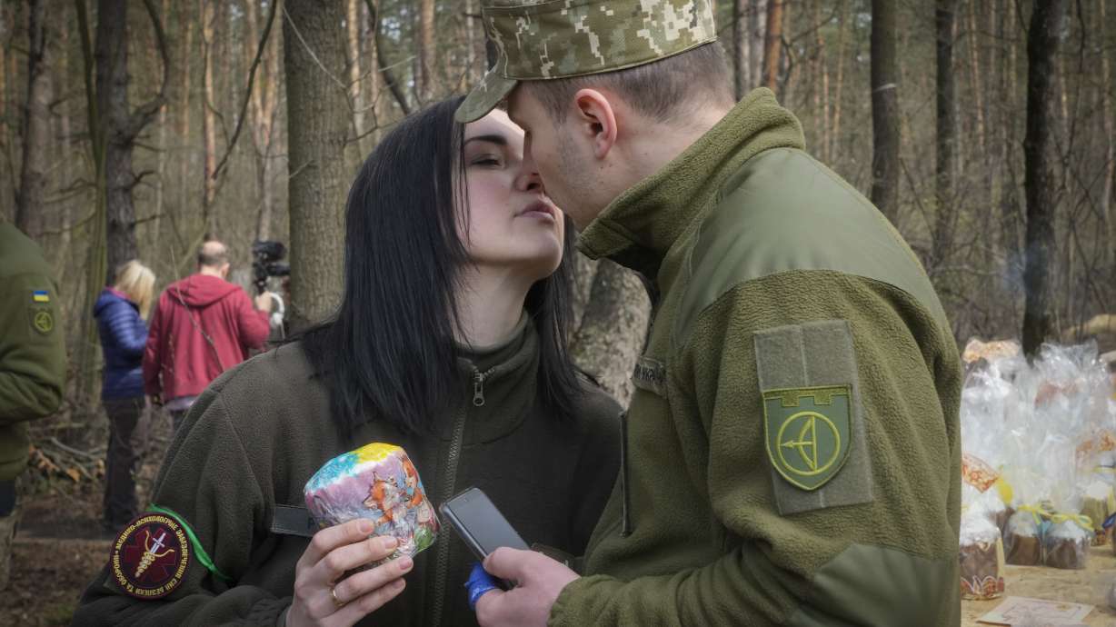 A military couple share a tender moment after an Easter cakes blessing ceremony on Easter eve at a military position outside Kyiv, Ukraine, Saturday.