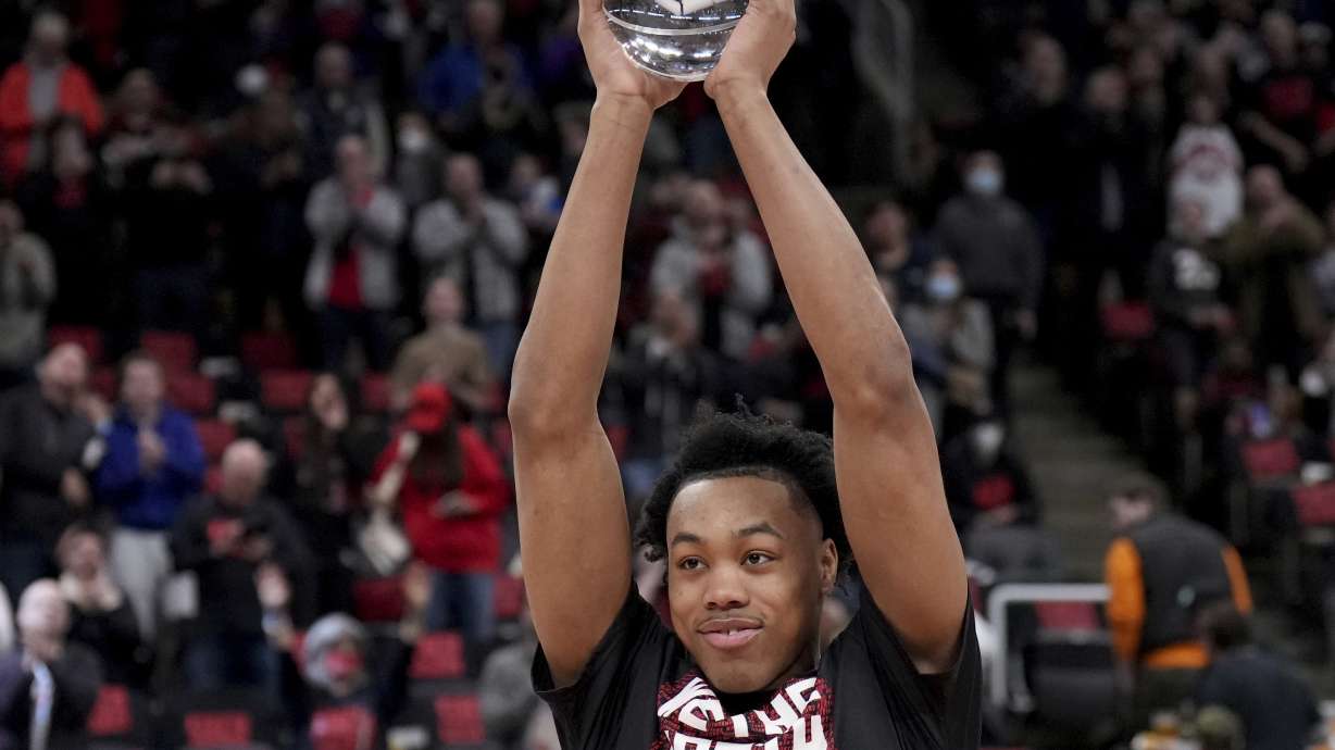 NBA Rookie of the Year, Toronto Raptors forward Scottie Barnes (4) holds up the trophy prior to the first half of Game 4 of an NBA basketball first-round playoff series against the Philadelphia 76ers Saturday, April 23, 2022 in Toronto.