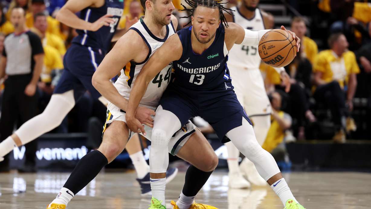 Utah Jazz forward Bojan Bogdanovic (44) makes Dallas Mavericks guard Jalen Brunson (13) work as he brings the ball up court as the Utah Jazz and the Dallas Mavericks play game three at Vivint Arena in Salt Lake City on Saturday, April 23, 2022.