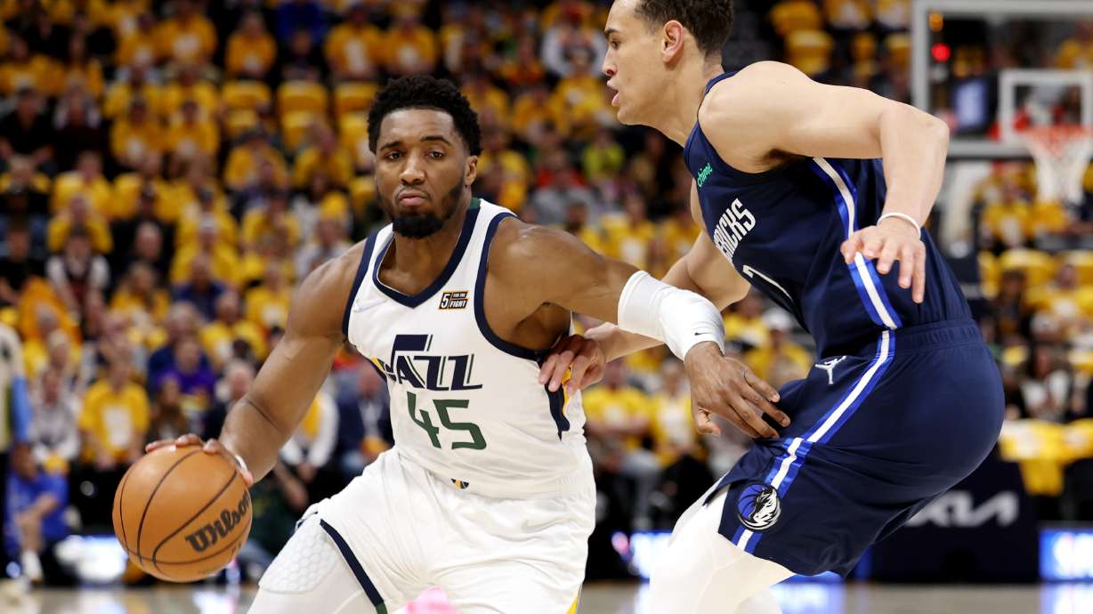 Utah Jazz guard Donovan Mitchell (45) drives around Dallas Mavericks center Dwight Powell (7) as the Utah Jazz and the Dallas Mavericks play game three at Vivint Arena in Salt Lake City on Saturday, April 23, 2022.