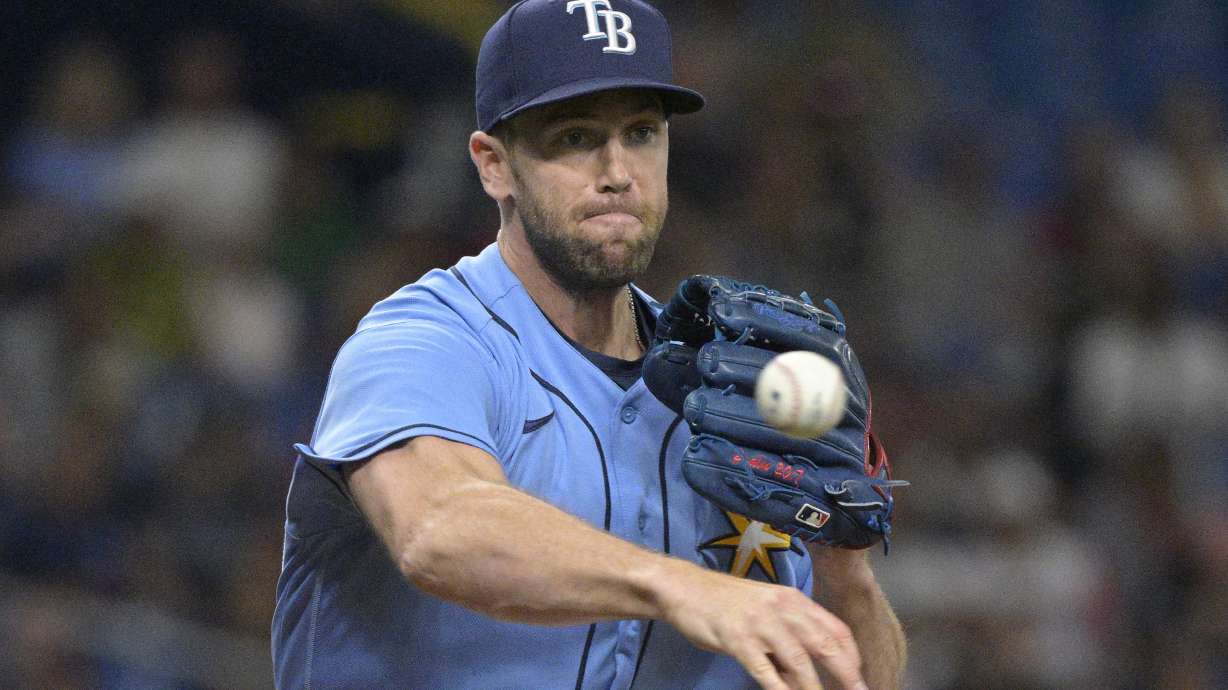 Tampa Bay Rays relief pitcher Jason Adam attempts to pick off Boston Red Sox's Trevor Story at first base during the fifth inning of a baseball game, Saturday, April 23, 2022, in St. Petersburg, Fla.