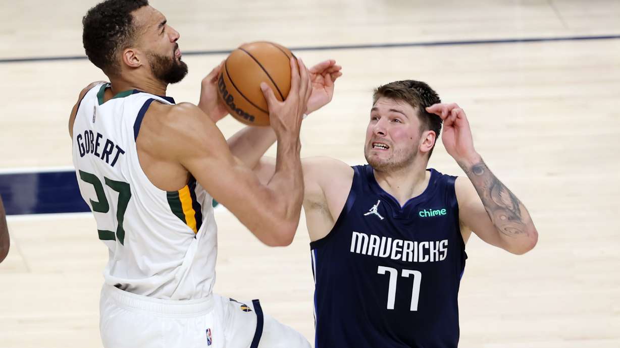 Utah Jazz center Rudy Gobert (27) goes at the rim with Dallas Mavericks guard Luka Doncic (77) defending as the Utah Jazz and the Dallas Mavericks play game four at Vivint Arena in Salt Lake City on Saturday, April 23, 2022. Utah won 100-99.