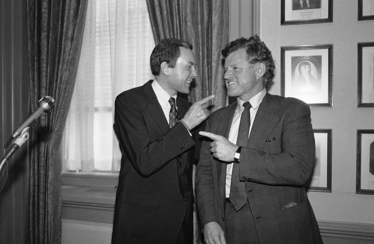 Sen. Orrin Hatch, R-Utah, left, and Sen. Edward M. Kennedy, D-Mass., do some finger-pointing before a press conference at the Capitol by members of the Senate Labor and Human Resources Committee in Washington on June 11, 1981.