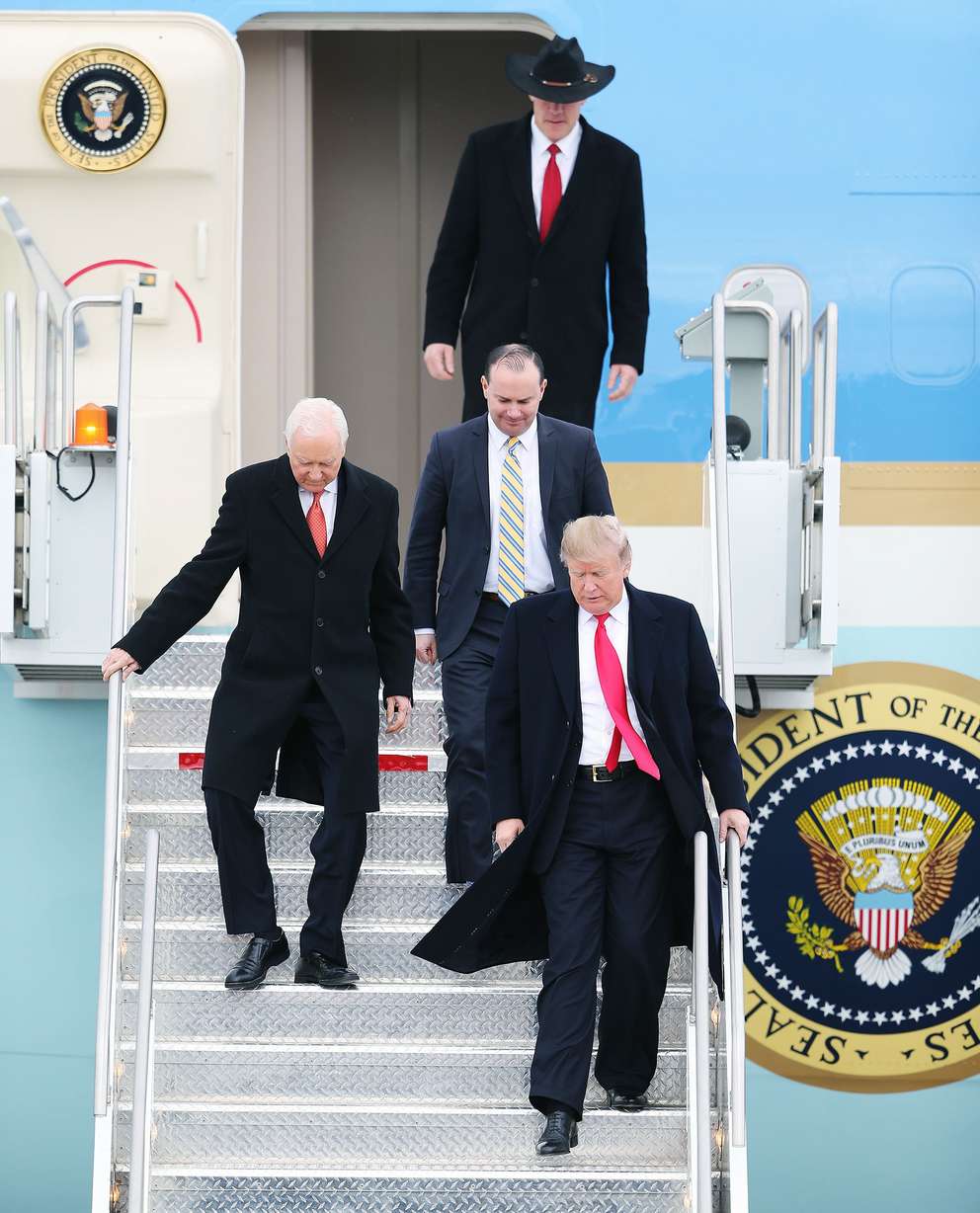 President Donald Trump steps off Air Force One with Utah Sens. Orrin Hatch, left, and Mike Lee, and Interior Secretary Ryan Zinke at Roland R. Wright Air National Guard Base at the Salt Lake City International Airport in Salt Lake City on Dec. 4, 2017.