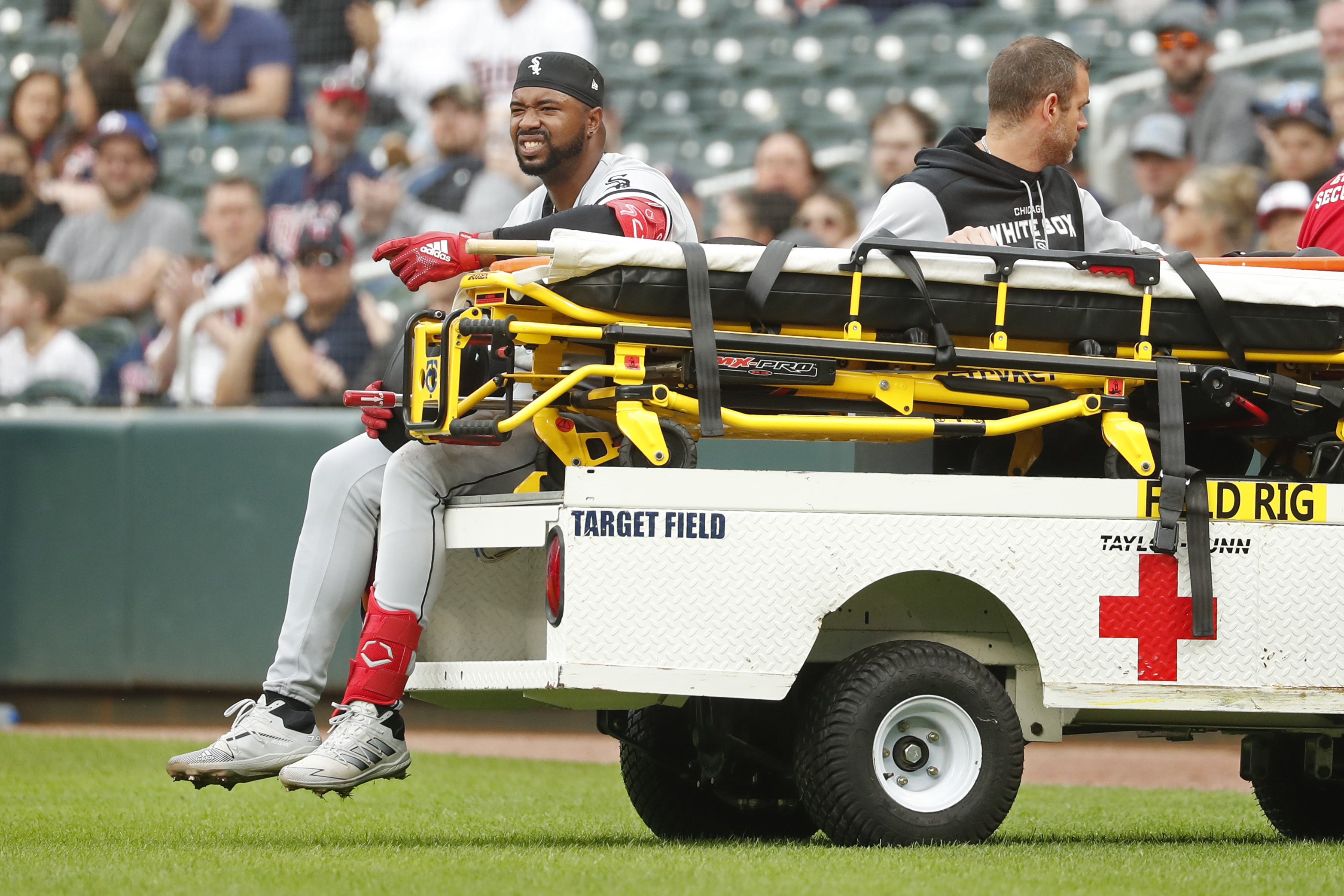 Chicago White Sox's Eloy Jimenez leaves the field on a cart after falling to the turf on a groundout to the Minnesota Twins in the second inning of a baseball game Saturday, April 23, 2022, in Minneapolis. 