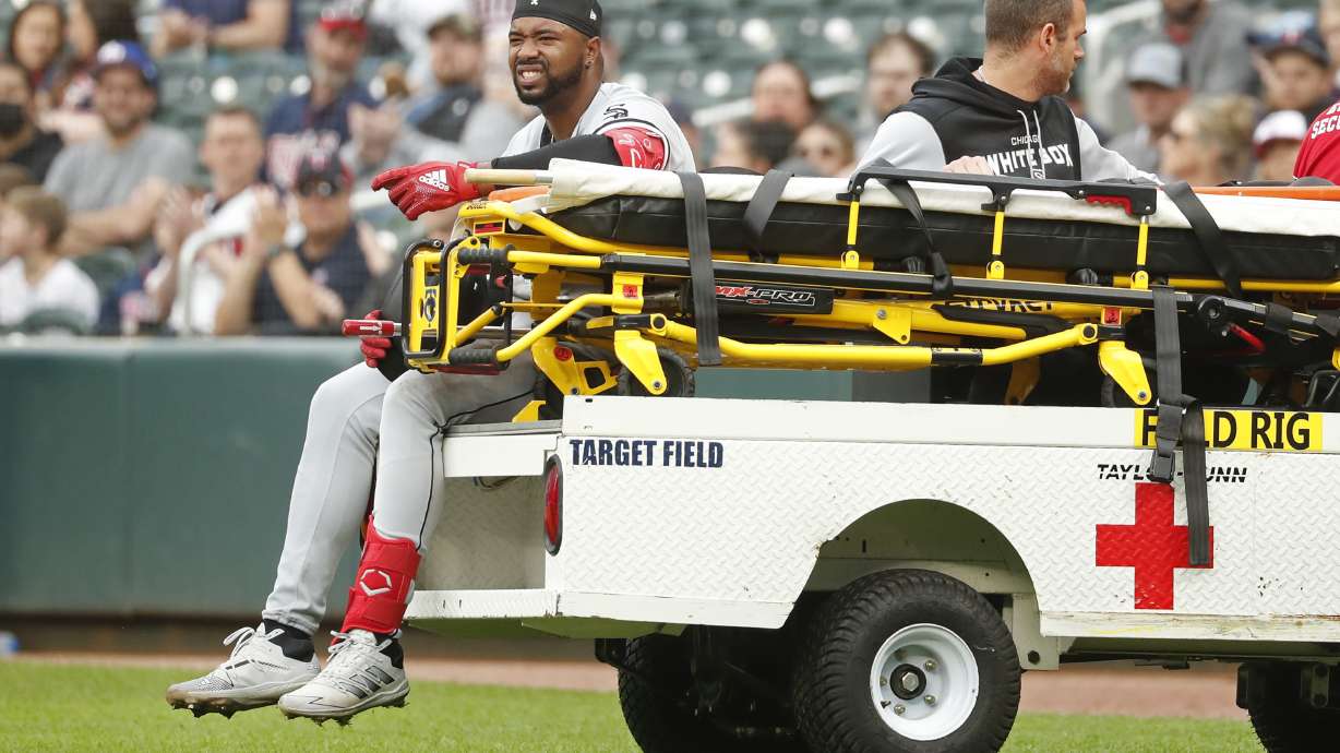 Chicago White Sox's Eloy Jimenez leaves the field on a cart after falling to the turf on a groundout to the Minnesota Twins in the second inning of a baseball game Saturday, April 23, 2022, in Minneapolis.