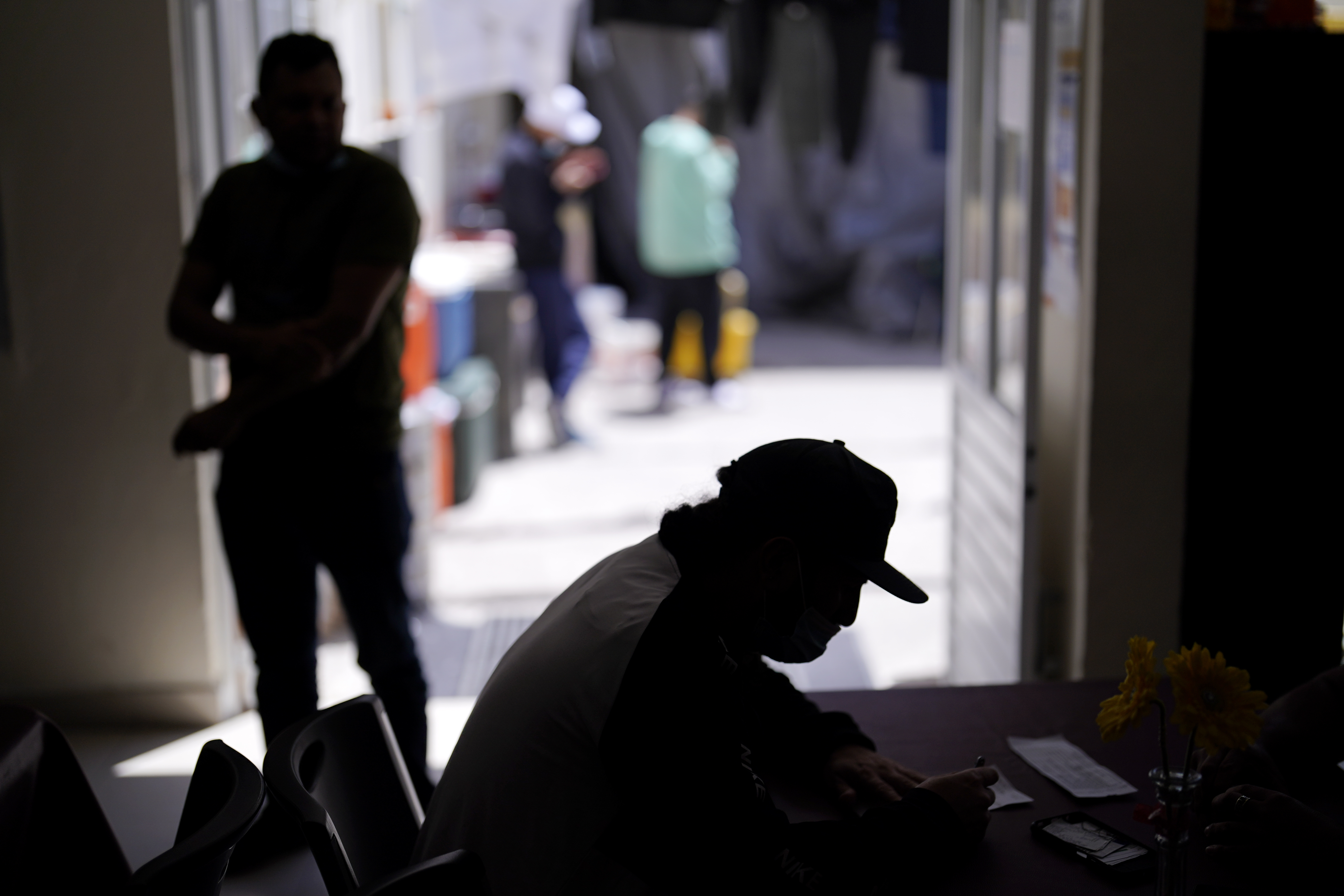 A man from Nicaragua sits at a shelter for migrants Thursday in Tijuana, Mexico. The man is waiting in Mexico for hearings in U.S. immigration court, part of a Trump-era policy that will be argued Tuesday before the U.S. Supreme Court. 