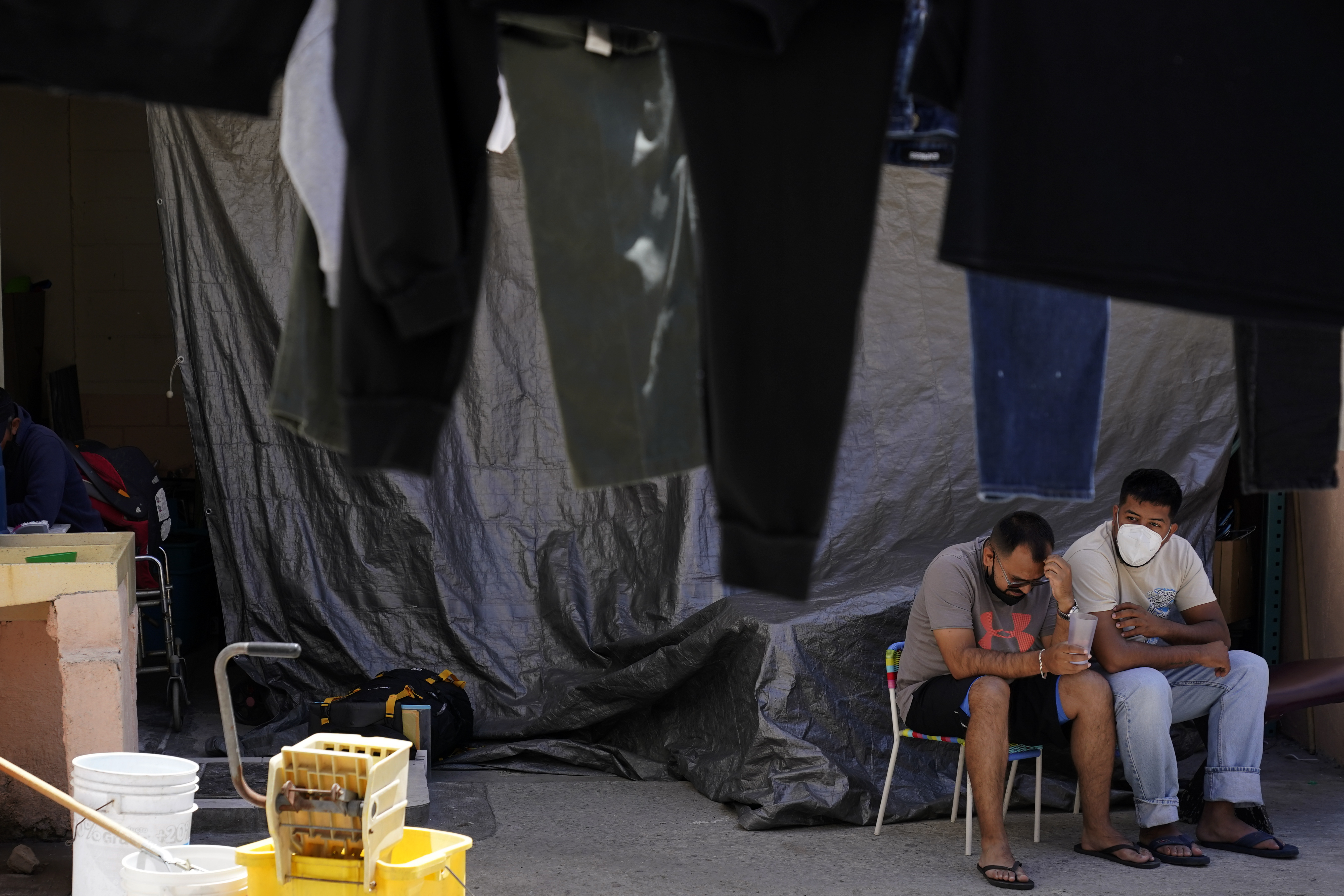 Men wait at a shelter for migrants Thursday, in Tijuana, Mexico. A critical Trump-era policy that forces asylum-seekers to wait in Mexico for hearings in U.S. immigration court will be argued Tuesday before the U.S. Supreme Court.