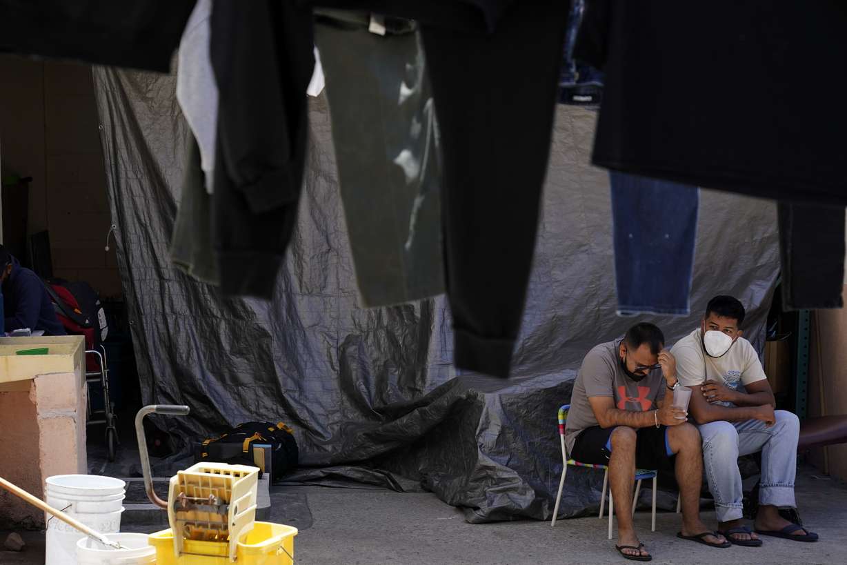Men wait at a shelter for migrants Thursday, in Tijuana, Mexico. A critical Trump-era policy that forces asylum-seekers to wait in Mexico for hearings in U.S. immigration court will be argued Tuesday before the U.S. Supreme Court.
