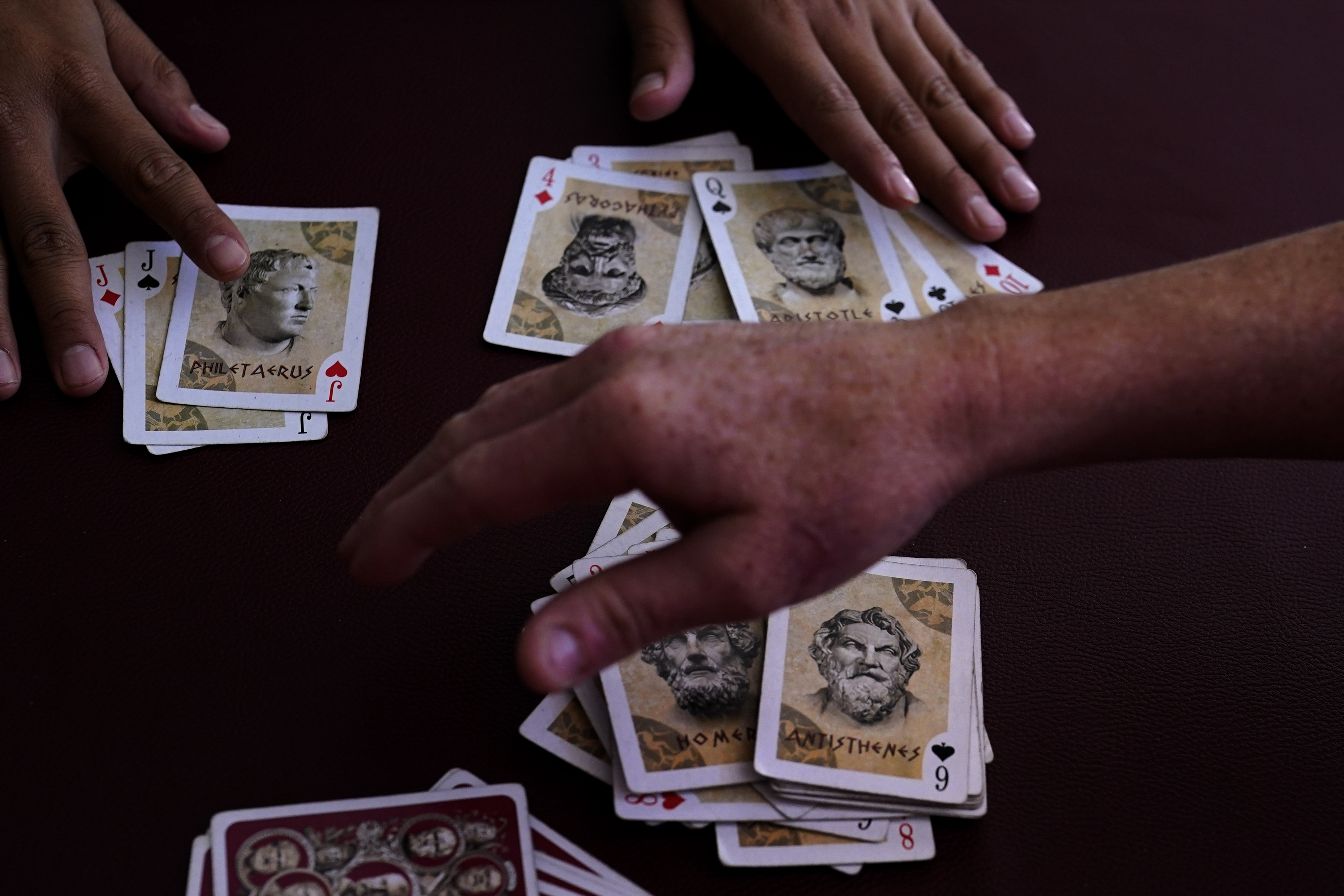 Men pass the time playing cards a shelter for migrants Thursday in Tijuana, Mexico. A critical Trump-era policy that forces asylum-seekers to wait in Mexico for hearings in U.S. immigration court will be argued Tuesday before the U.S. Supreme Court.