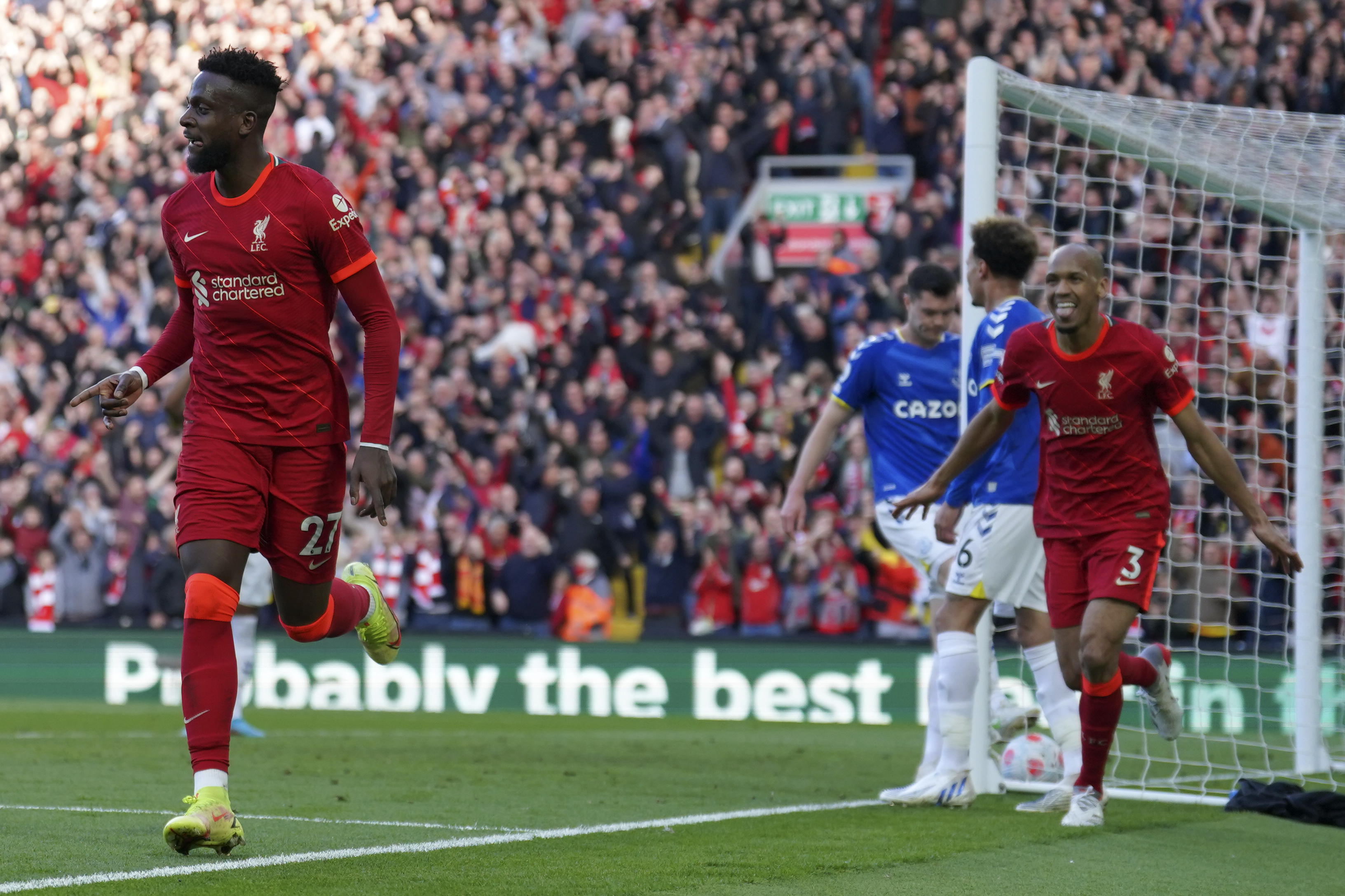 Liverpool's Divock Origi, left, celebrates after scoring his sides second goal during the English Premier League soccer match between Liverpool and Everton at Anfield stadium in Liverpool, England, Sunday, April 24, 2022. 