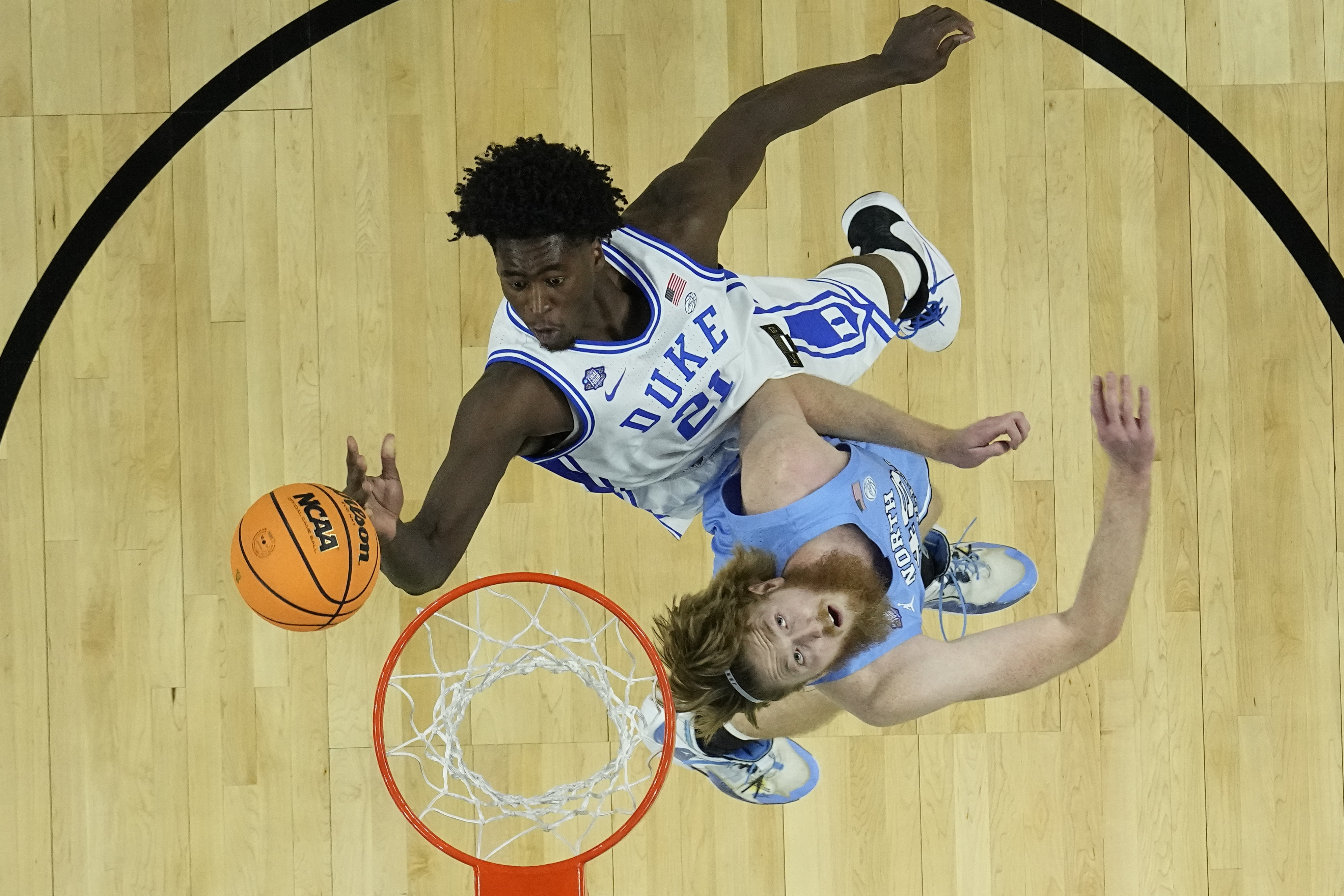 Duke's AJ Griffin (21) shoots over North Carolina's Brady Manek during the first half of a college basketball game in the semifinal round of the Men's Final Four NCAA tournament, Saturday, April 2, 2022, in New Orleans. 