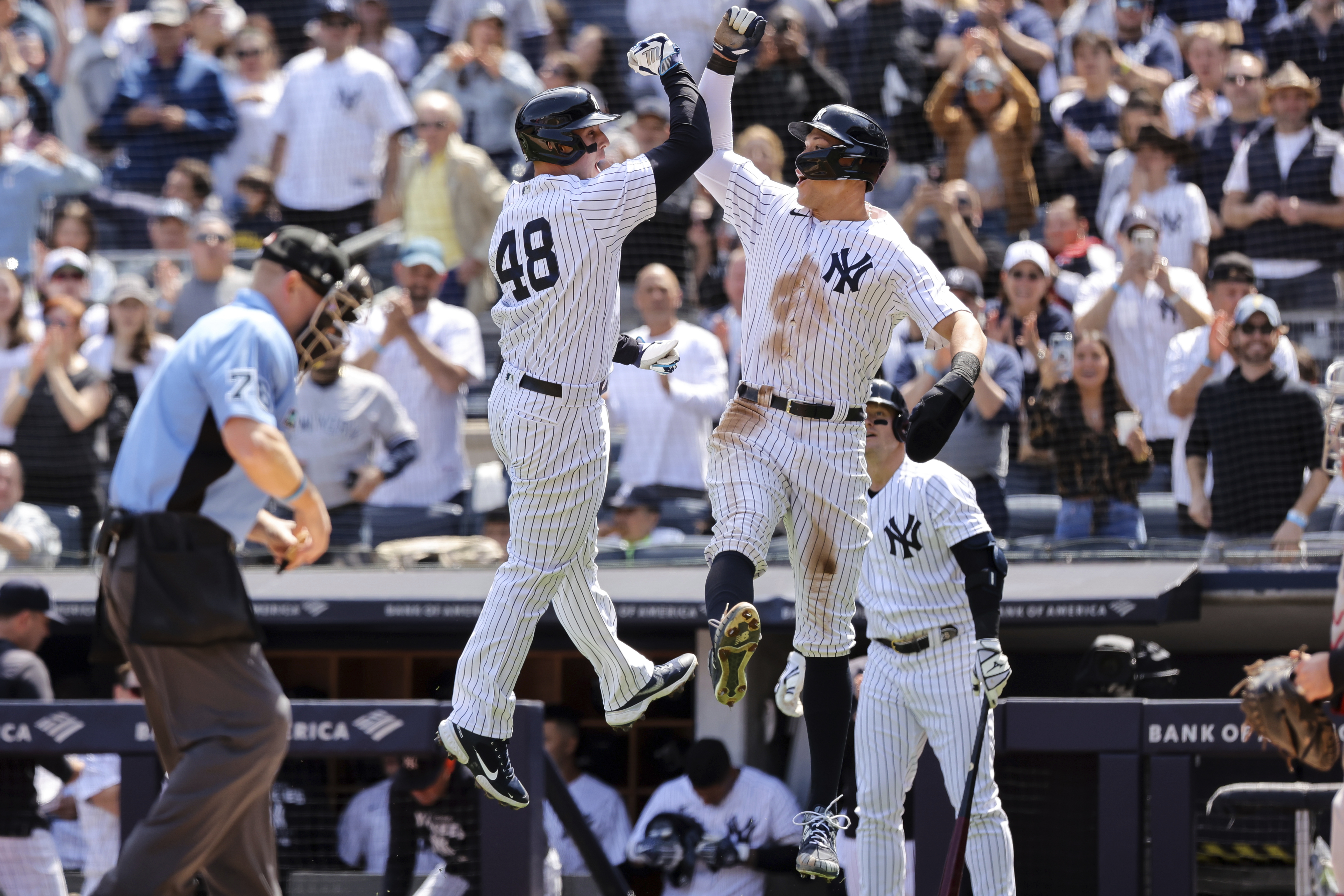 New York Yankees' Anthony Rizzo (48) and Yankees' Aaron Judge celebrate after Rizzo's home run against the Cleveland Guardians during the first inning of a baseball game, Sunday, April 24, 2022, in New York. 