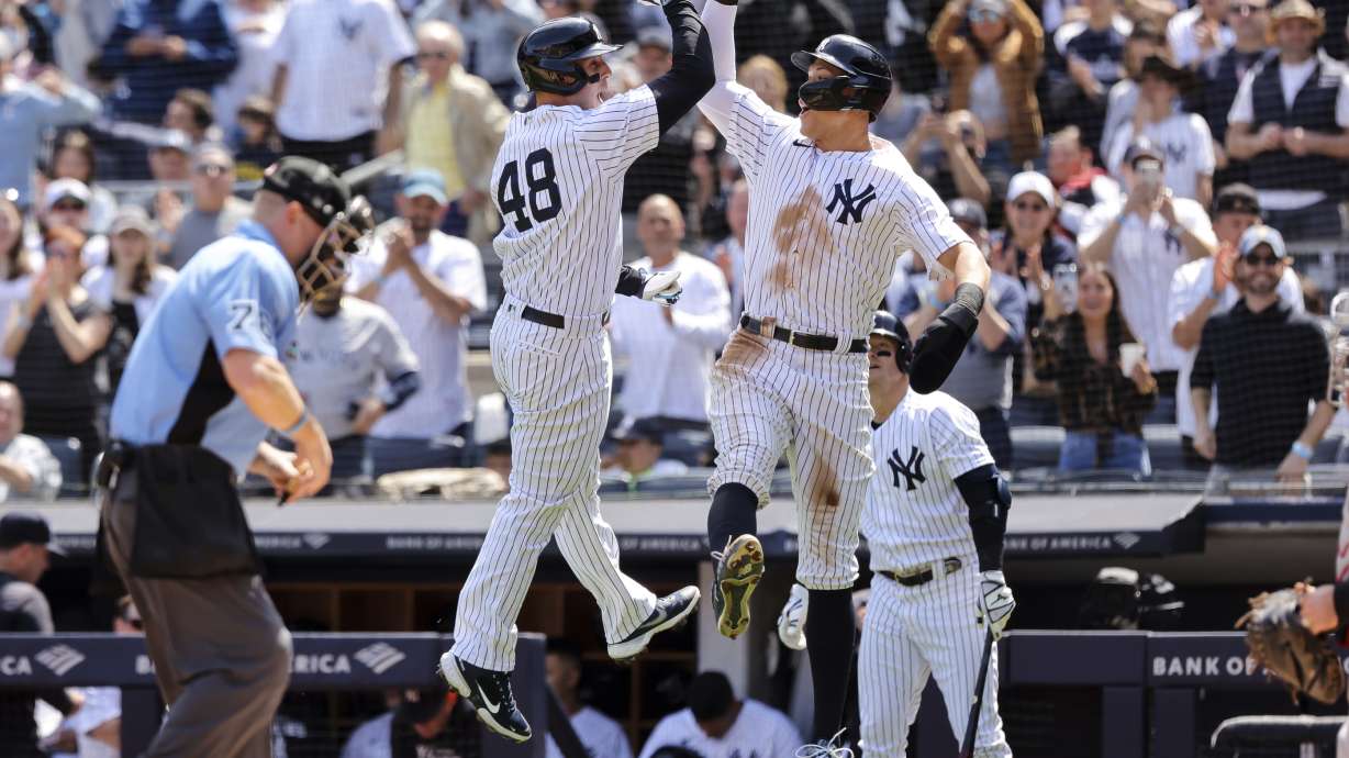New York Yankees' Anthony Rizzo (48) and Yankees' Aaron Judge celebrate after Rizzo's home run against the Cleveland Guardians during the first inning of a baseball game, Sunday, April 24, 2022, in New York.