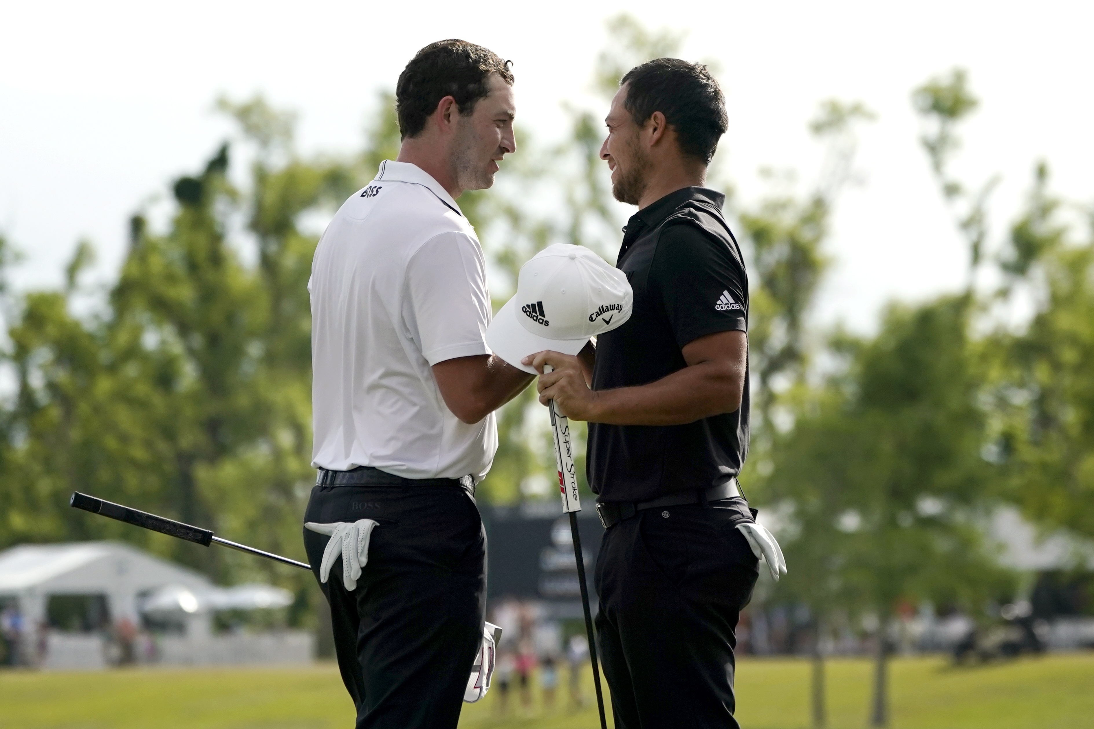 Patrick Cantlay and his teammate Xander Schauffele, right, congratulate each other after their win in the PGA Zurich Classic golf tournament at TPC Louisiana in Avondale, La., Sunday, April 24, 2022. 