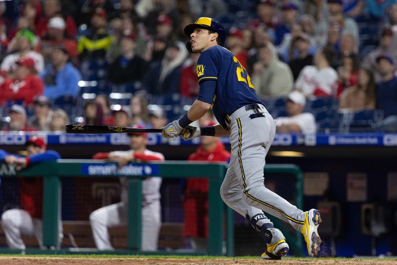 Apr 24, 2022; Philadelphia, Pennsylvania, USA; Milwaukee Brewers left fielder Christian Yelich (22) hits an RBI sacrifice fly during the ninth inning against the Philadelphia Phillies at Citizens Bank Park.