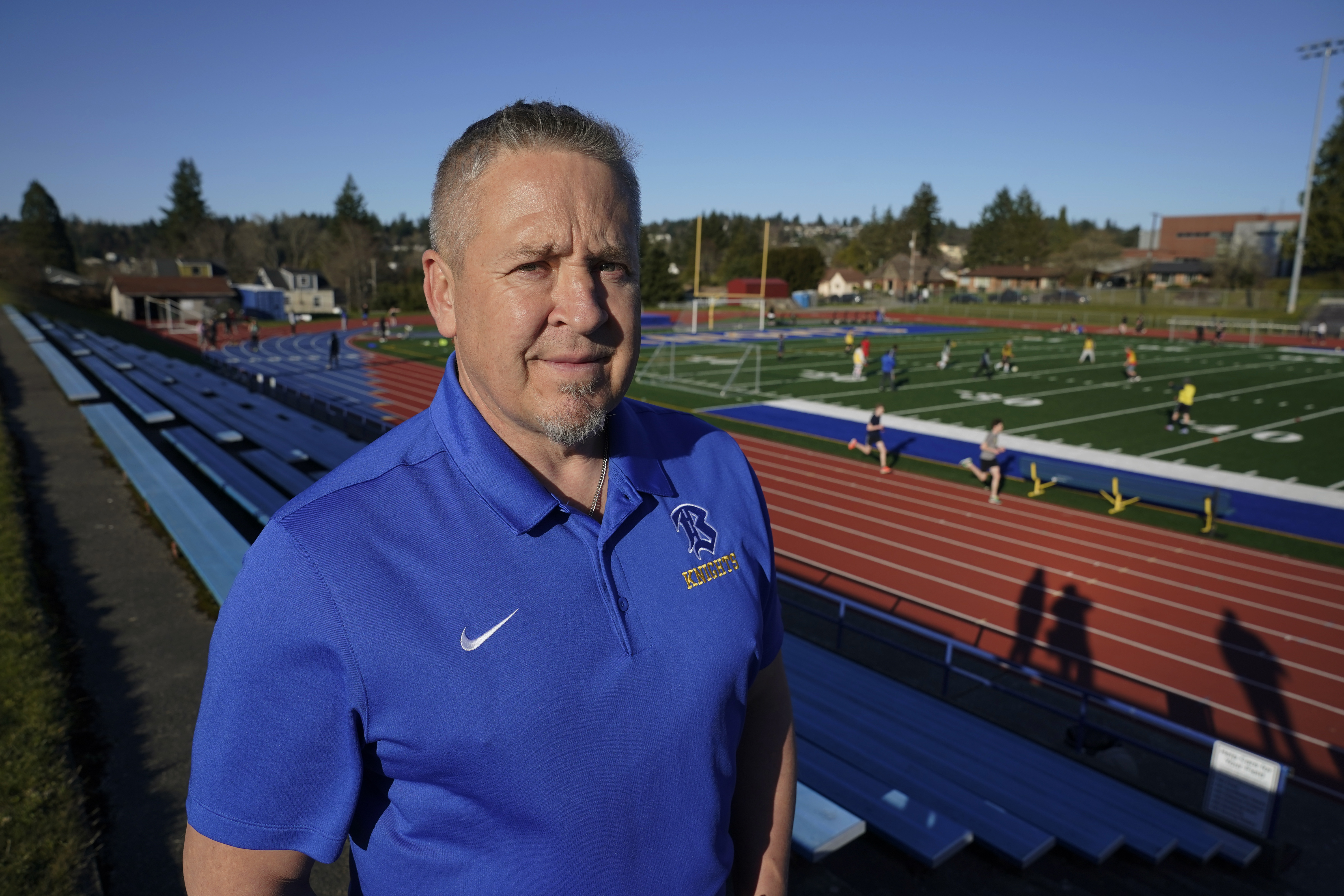 Joe Kennedy, a former assistant football coach at Bremerton High School in Bremerton, Wash., poses for a photo March 9,  at the school's football field. The Supreme Court is siding with him Monday.