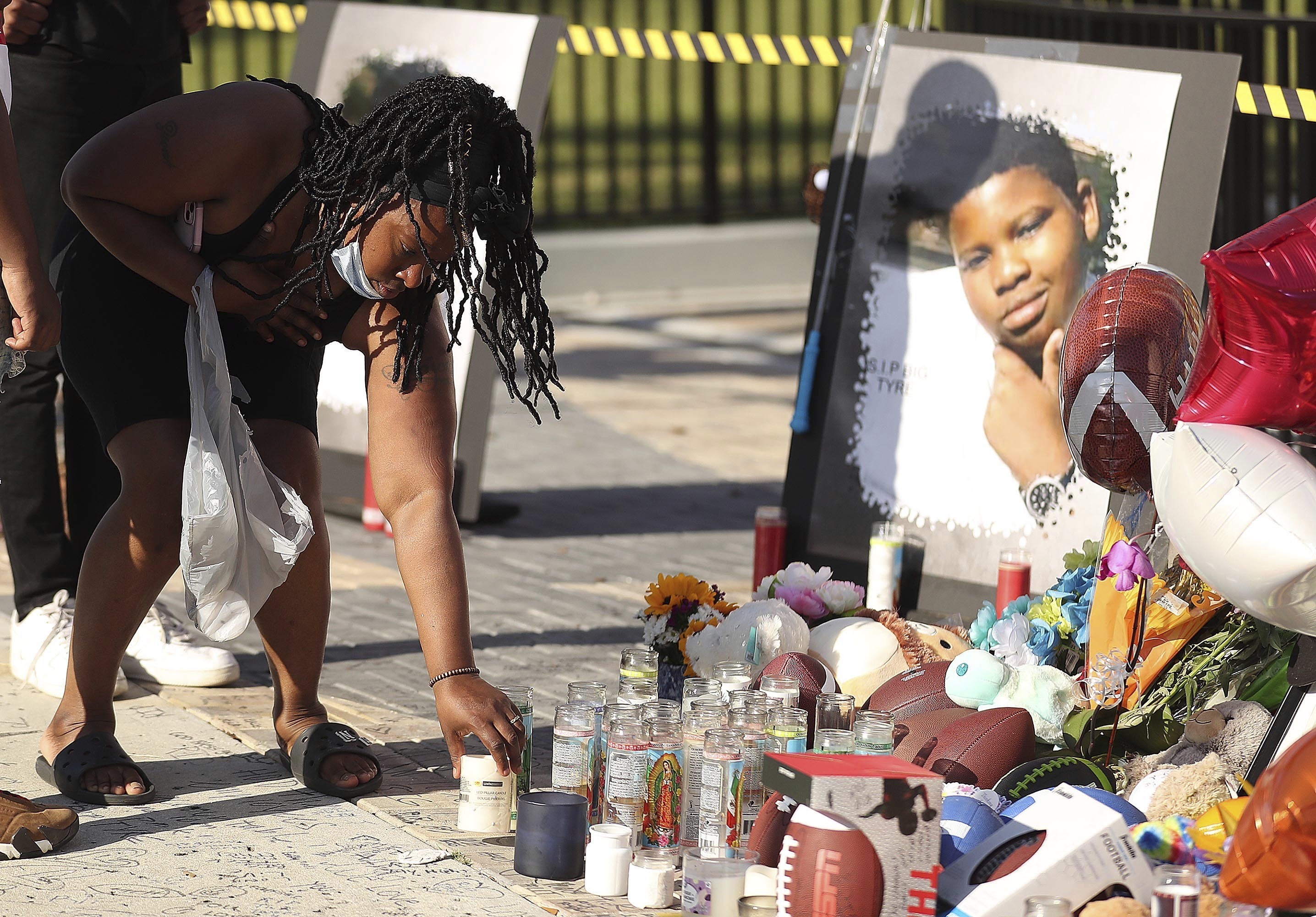 Family members and friends of Tyre Sampson, 14, leave items during a vigil in front of the Orlando Free Fall drop tower in ICON Park in Orlando on March 28. Sampson's parents filed a lawsuit after the teen fell to his death.