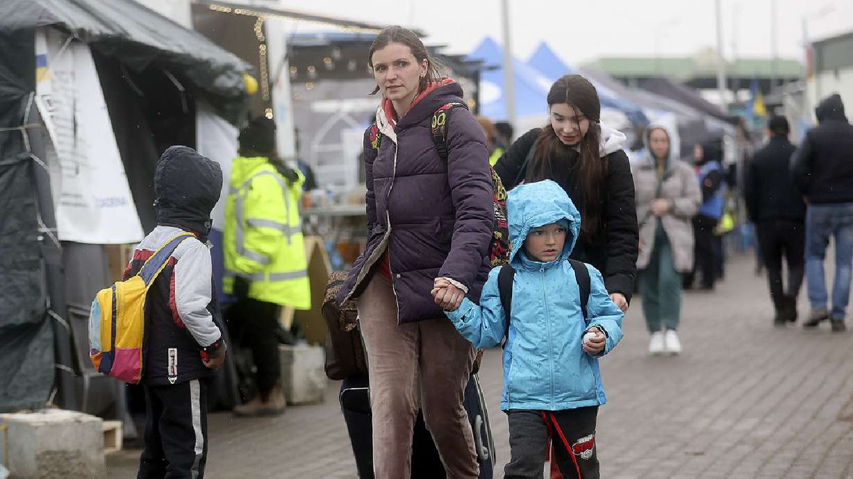 Katerina Taran, from Kharkiv, holds the hand of her son, Artyom Chepel, 4, after crossing the Ukrainian-Polish border with Taran’s niece and other son in Medyka, Poland, on Thursday.