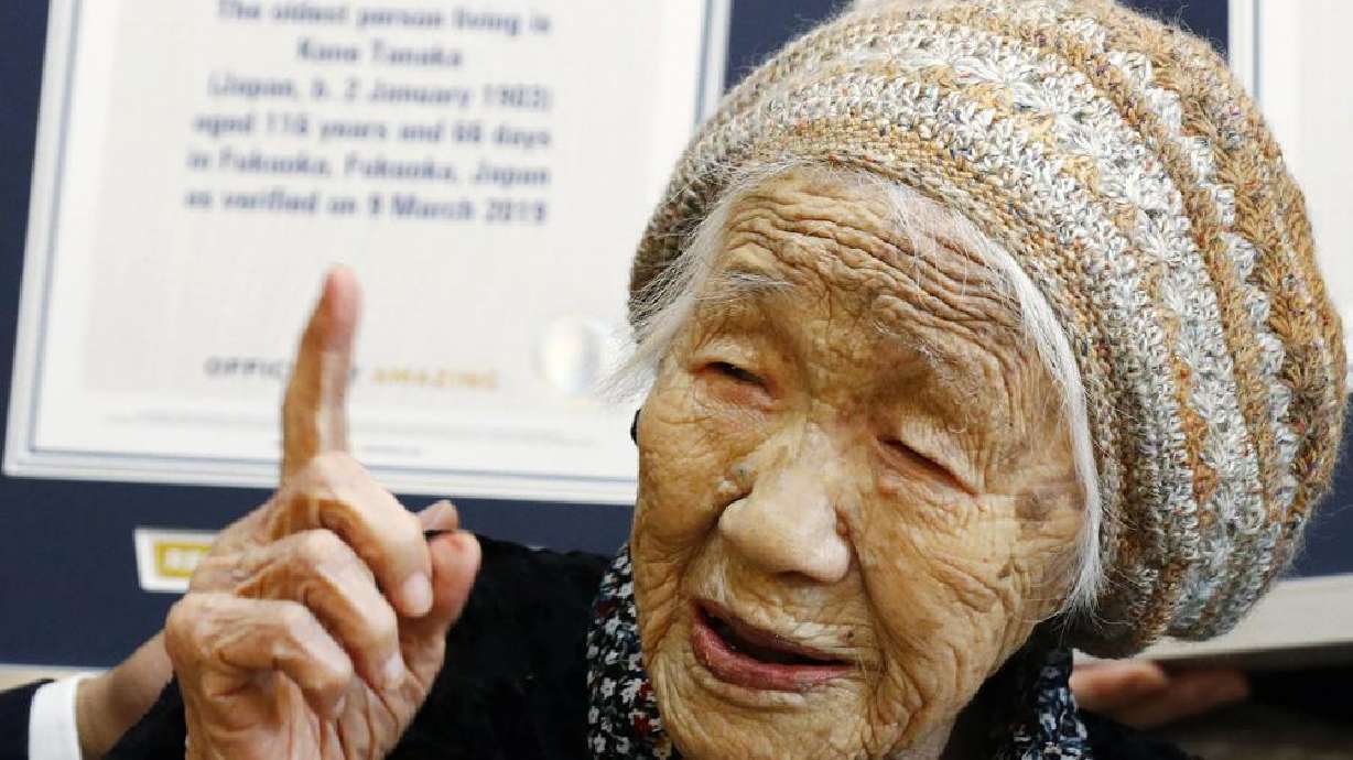 Kane Tanaka, then 116 years old, reacts after receiving a Guinness World Records certificate, background, at a nursing home where she lives in Fukuoka, Japan on March 9, 2019. The woman recognized as the world’s oldest person has died at age 119, just months short of her goal of reaching 120.