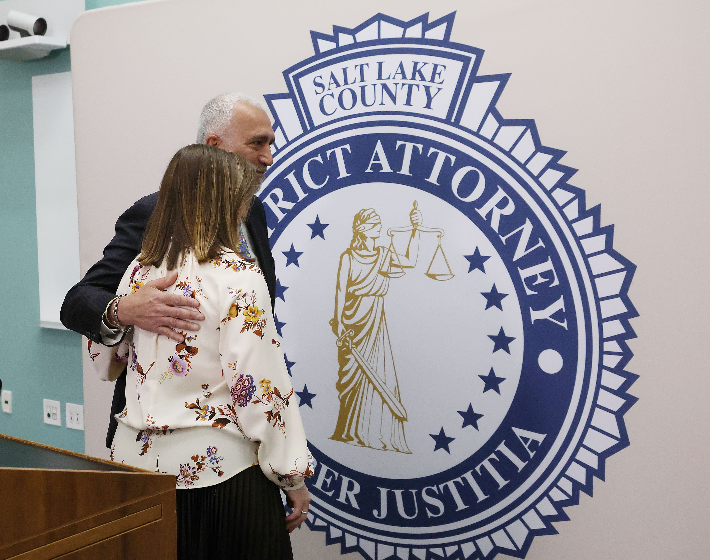 Salt Lake County Mayor Jenny Wilson and Salt Lake County District Attorney Sim Gill hug after a press conference to announce a $57 million settlement with pharmaceutical companies to fight the opioid epidemic, in Salt Lake City on Tuesday.