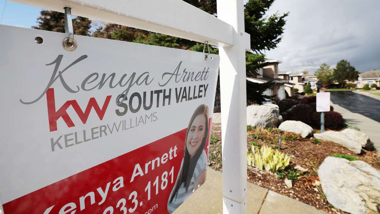 A “for sale” sign is pictured at a home in Cottonwood Heights on Friday, April 15, 2022. Home prices in major cities across the nation increased 19.8% in February year over year, according to the latest figures reported from the S&P CoreLogic Case-Shiller national home price index.