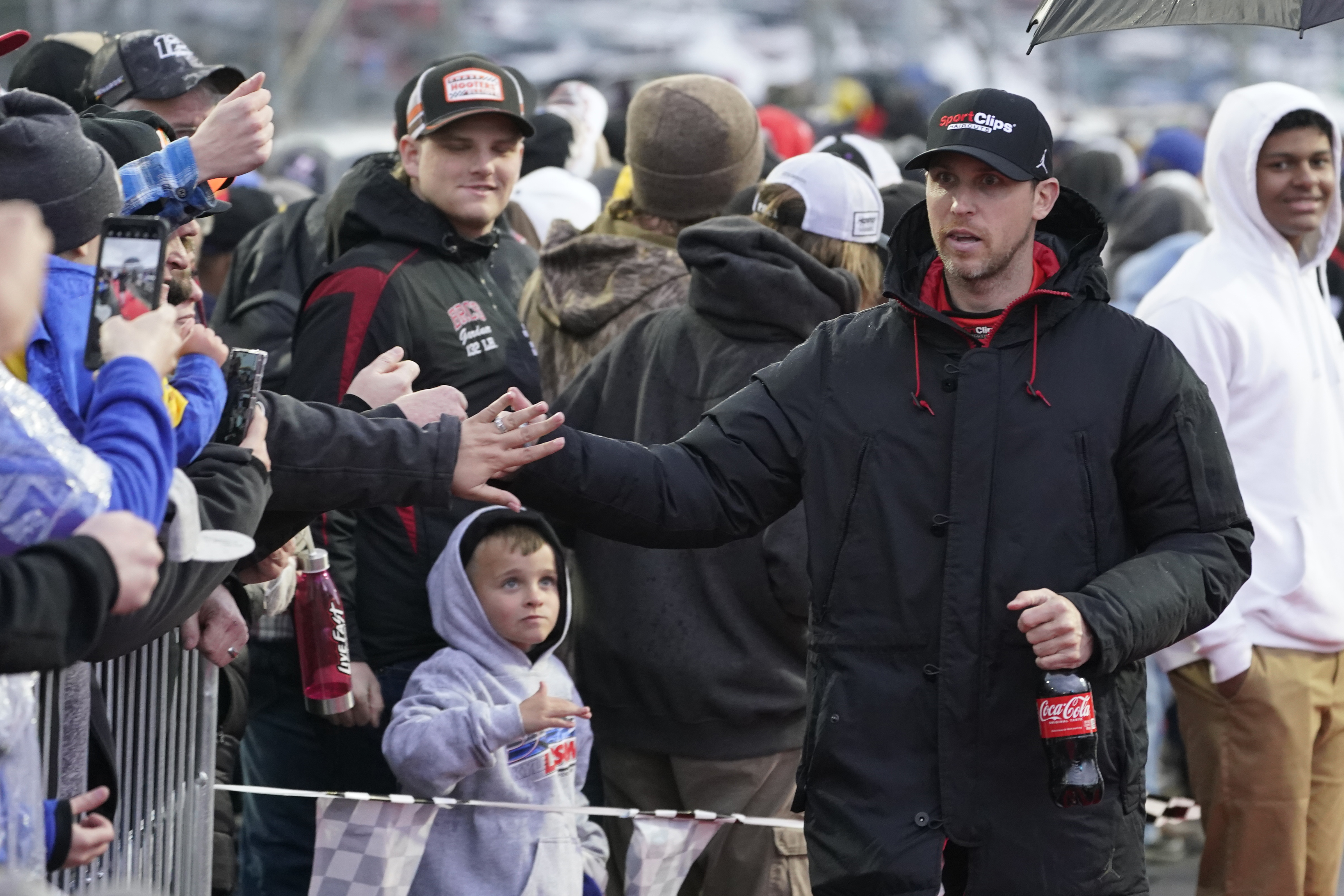 Denny Hamlin, righ, greets fans before the NASCAR Cup Series auto race at Martinsville Speedway on Saturday, April 9, 2022, in Martinsville, Va. 