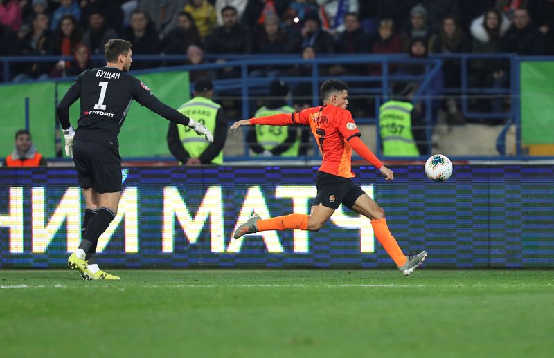 FILE PHOTO: Soccer Football - Ukrainian Premier League - Shakhtar Donetsk v Dynamo Kiev - Metalist Stadium, Kharkiv, Ukraine - November 10, 2019. Dynamo Kiev's Heorhiy Bushchan attempts to stop Shakhtar Donetsk's Taison, who kicks the ball in the direction of Dynamo Kiev's supporters while reacting to presumed racist insults. Picture taken November 10, 2019.