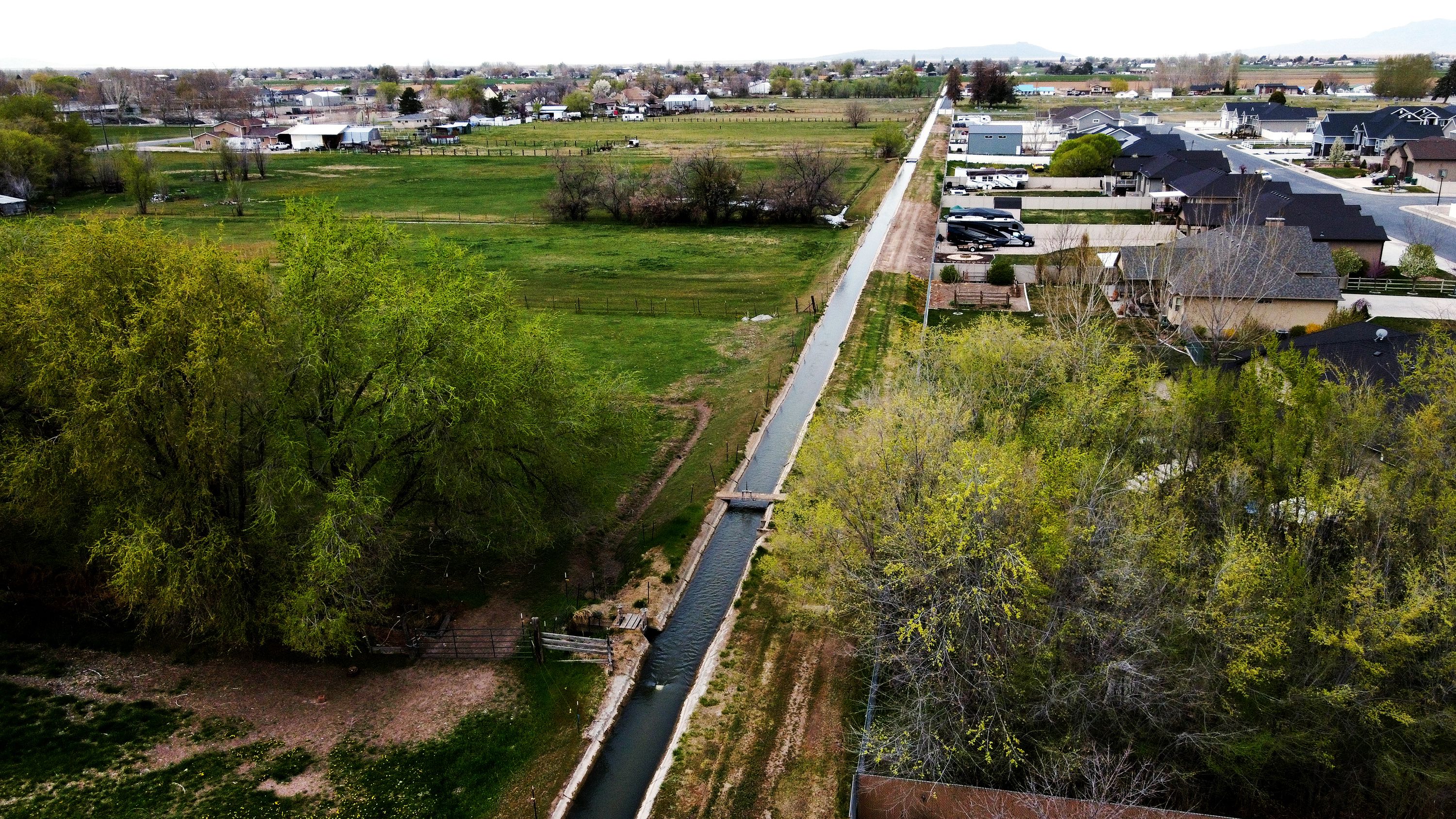 Water runs in an irrigation ditch in Hooper, Weber County, on Tuesday.