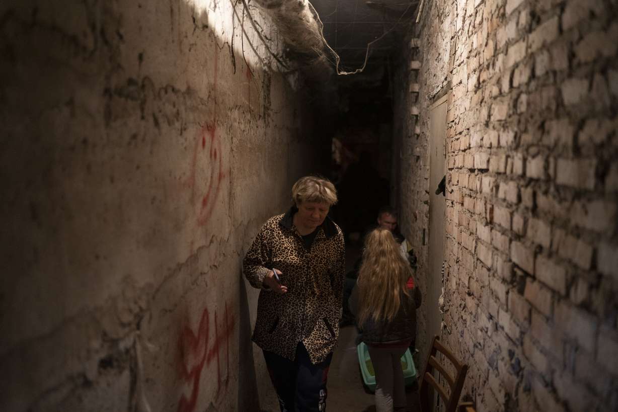 Helena walks inside the basement of a residential building during a Russian attack in Lyman, Ukraine, Tuesday. The 60-year-old woman says it's a very difficult moment.
