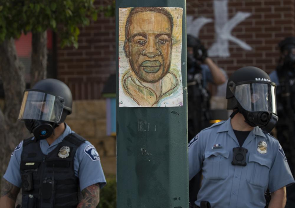 Minneapolis police stand outside the department's 3rd Precinct on May 27, 2020, in Minneapolis. Almost two years after George Floyd died at the hands of four Minneapolis police officers, a state investigation has determined that the department engages in a pattern of race discrimination.