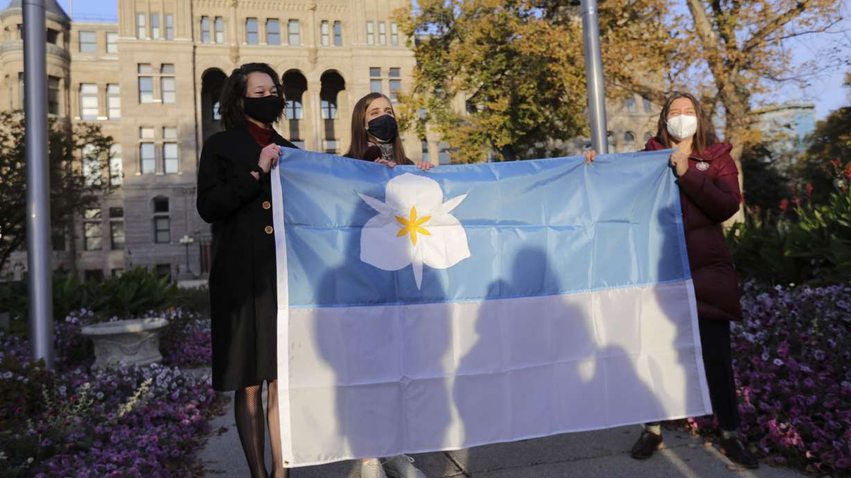 Ella Kennedy-Yoon, left, and Arianna Meinking, co-designers of Salt Lake City’s new flag, and Mayor Erin Mendenhall pose for a photo with the flag during a flag-raising ceremony on Oct. 23, 2020. The flag ended up fifth on a list of 312 city flags designed since 2015, according to a North American Vexillological Association survey.