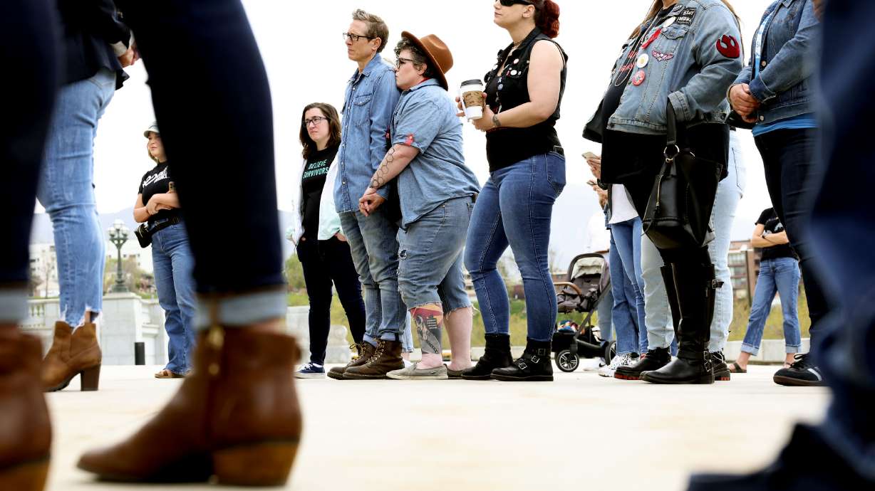 People listen to speakers during Denim Day at the Capitol in Salt Lake City on Wednesday.