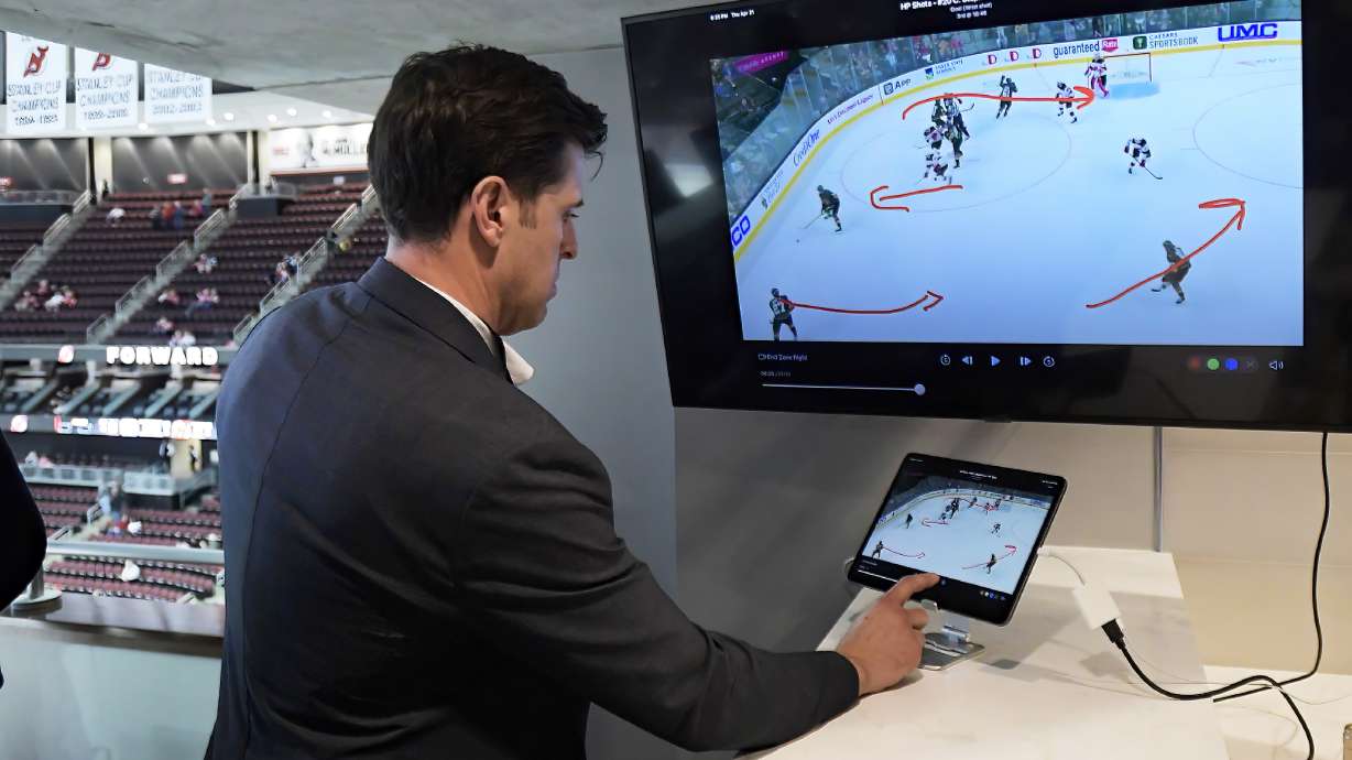 NHL senior director of coaching and general manager of technology Brant Berglund demonstrates the latest advances in puck and player tracking at a tech showcase before an NHL hockey game between the Buffalo Sabres and New Jersey Devils,Thursday, April 21, 2022, in Newark, N.J. Some data from the NHL’s puck and player tracking system is expected to be publicly available during the upcoming playoffs, and that’s just the start of some of the technological twists that are coming to hockey arenas and broadcasts sooner than later. Custom camera angles and replays for fans at their seats and virtual and augmented reality are among the advancements the league is working on.