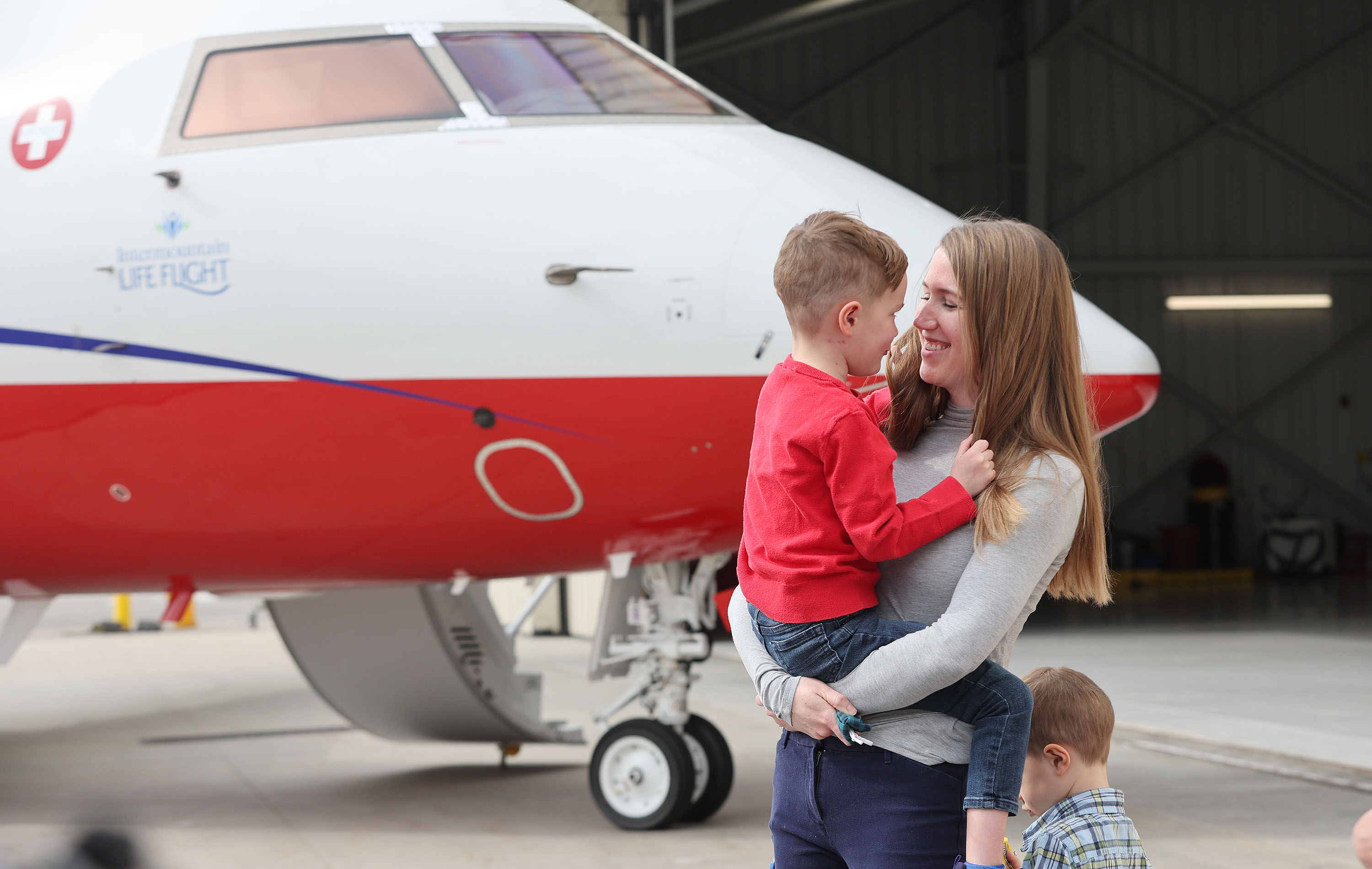 Brooke Partridge smiles with her son Ezra near Intermountain Life Flight’s new unique long-range medical jet in Salt Lake City on Wednesday. The jet will be used to transport patients for highly-specialized care and to enhance organ transplantation in Utah by retrieving donor organs from throughout the nation.