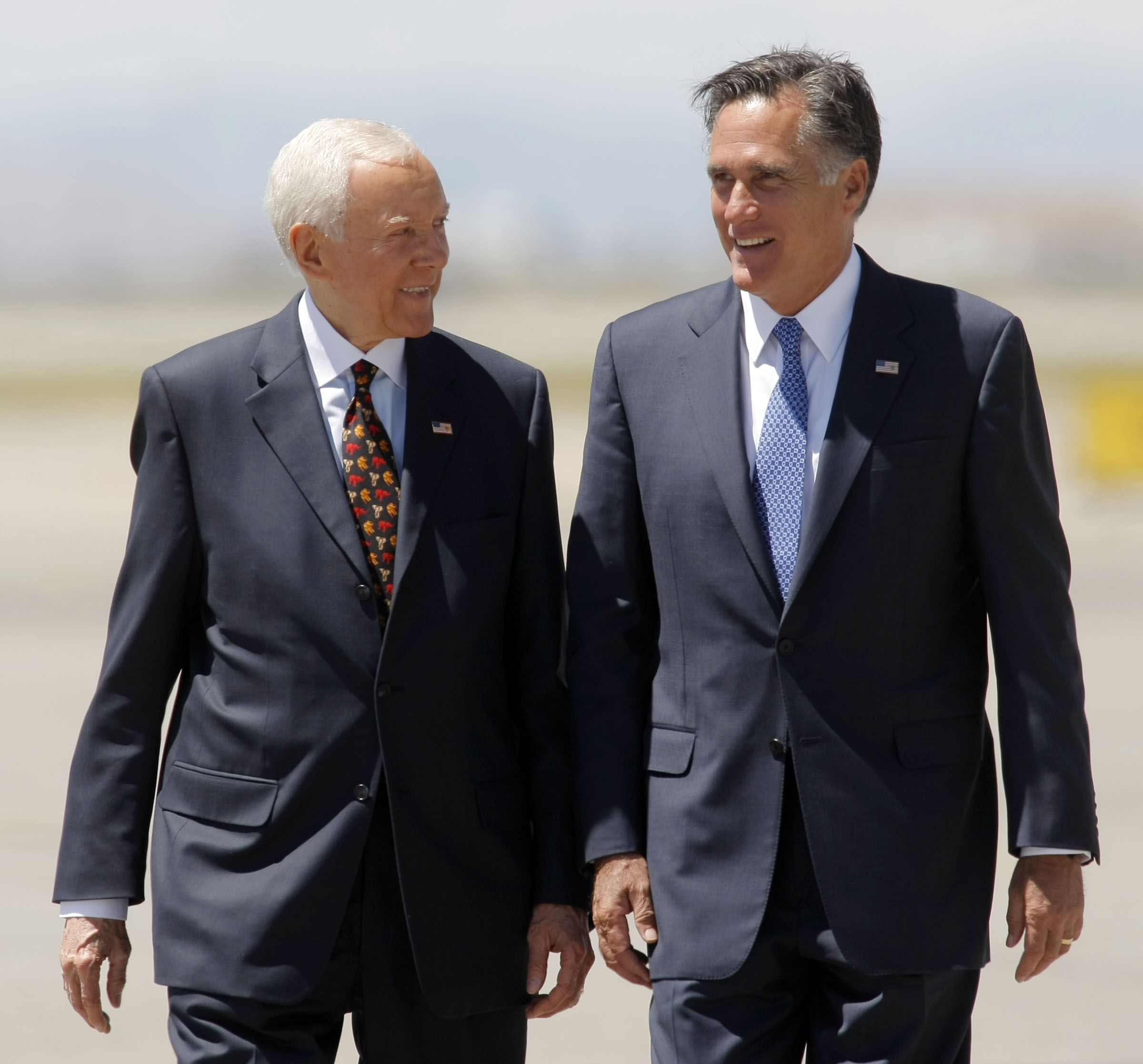 Utah Sen. Orrin Hatch greets then-presidential candidate Mitt Romney on June 8, 2012, at the Salt Lake executive terminal. Romney later was elected to Hatch’s seat the longtime senator retired. Hatch died Saturday at age 88.