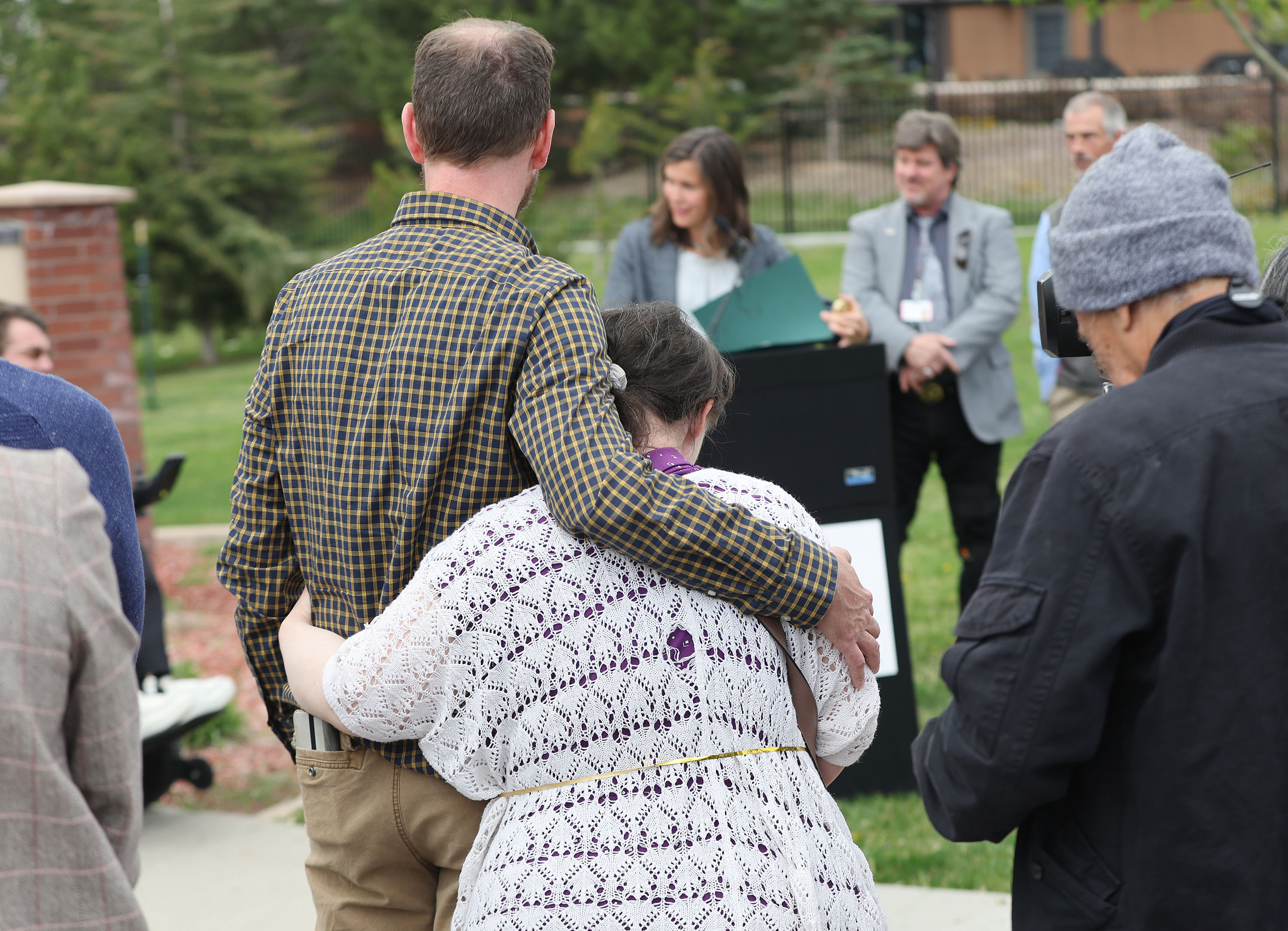 Vard McGuire, with the Disability Law Center, hugs his sister, Mindy McGuire, as Salt Lake City Mayor Erin Mendenhall reads a proclamation about Fair Housing Month and the need for accessibility in housing at a press conference in Salt Lake City on Wednesday.