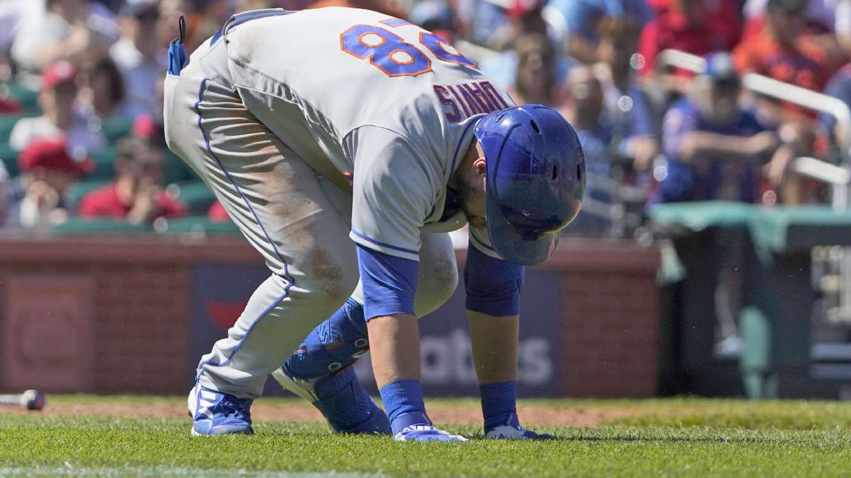 New York Mets' J.D. Davis doubles over after being hit by a pitch during the eighth inning of a baseball game against the St. Louis Cardinals Wednesday, April 27, 2022, in St. Louis. Davis left the game.