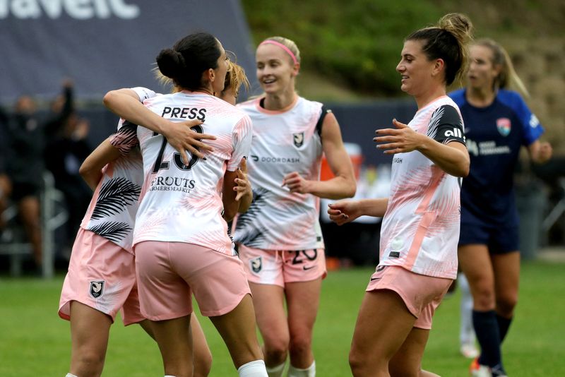 FILE PHOTO: Apr 2, 2022; San Diego, CA, USA; Angel City FC attacker Christen Press (23) celebrates with teammates after scoring a goal during the second half against the San Diego Wave FC at a NWSL Challenge Cup match at Torero Stadium.