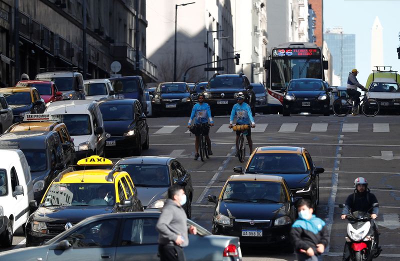 Leandro Blanco, 31, and Lucas Ledesma, 34,  members of a group of four that will make a cycling trip from the south of Africa to Qatar in time for the 2022 soccer World Cup, ride their bikes in Buenos Aires' downtown, Argentina April 28, 2022.