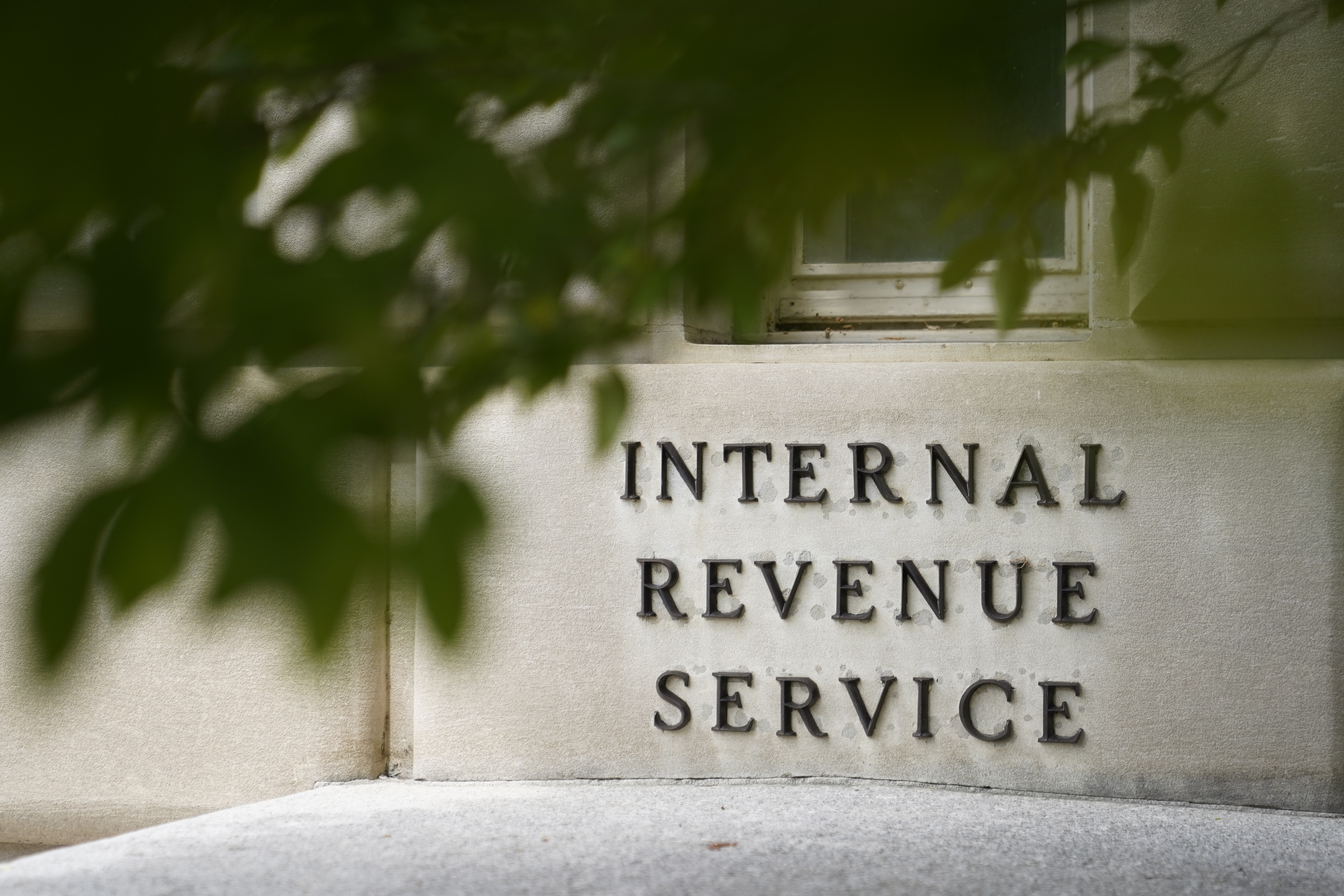 A sign is displayed outside the Internal Revenue Service building May 4, 2021, in Washington. A new government watchdog report finds that while most Americans are eligible to file their taxes for free, only a fraction use the services provided through the government. 