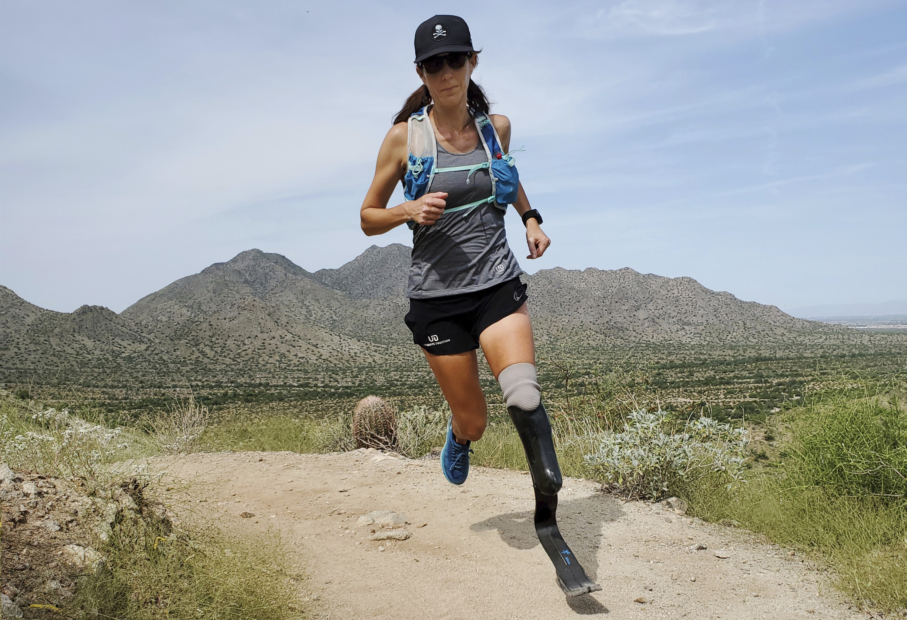 In this image provided by Edwin Broersma, marathoner Jacky Hunt-Broersma trains on Aug. 28, 2021 at San Tan Mountain Regional Park, in San Tan Valley, Az. Hunt-Broersma lost her left leg below the knee to a rare form of cancer, but she hasn't let that stop her and is trying to cover the classic 26.2-mile marathon distance at least 102 times in 102 days, which would set a new world record. The Boston Marathon on April 18 is expected to be No. 92 in her streak. 